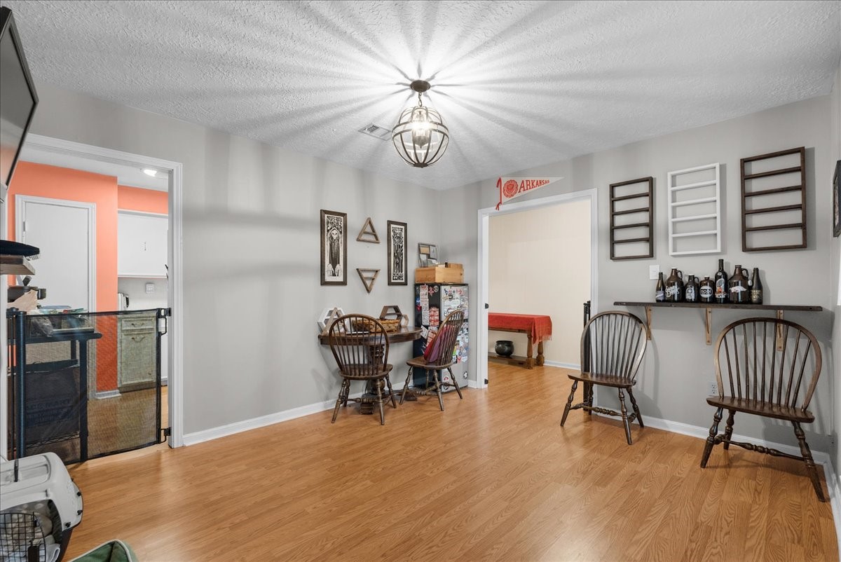 Dining area with decorative lighting, and flexible space for everyday meals. Dining area with decorative lighting, and flexible space for everyday meals.