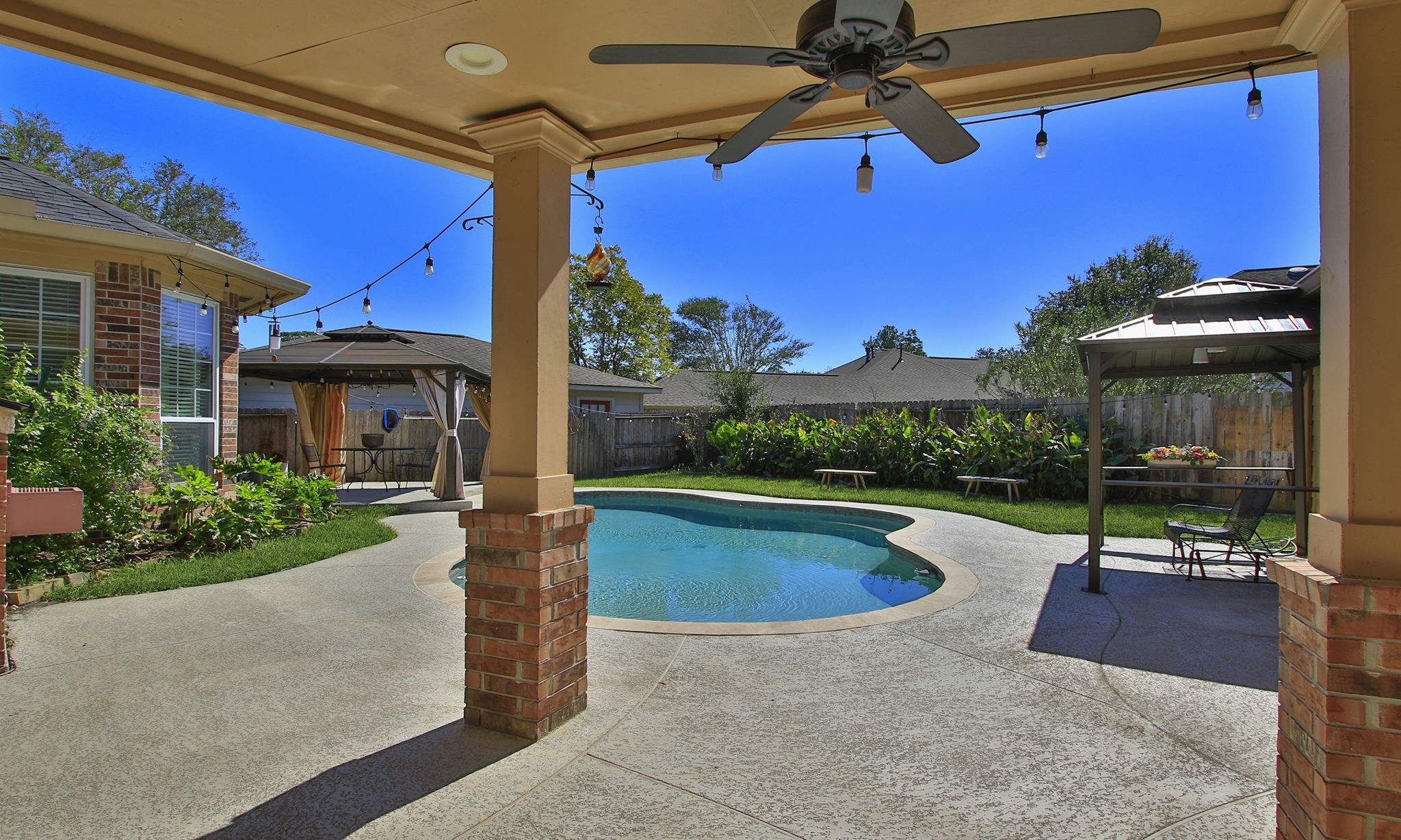 A true backyard oasis with multiple covered spaces