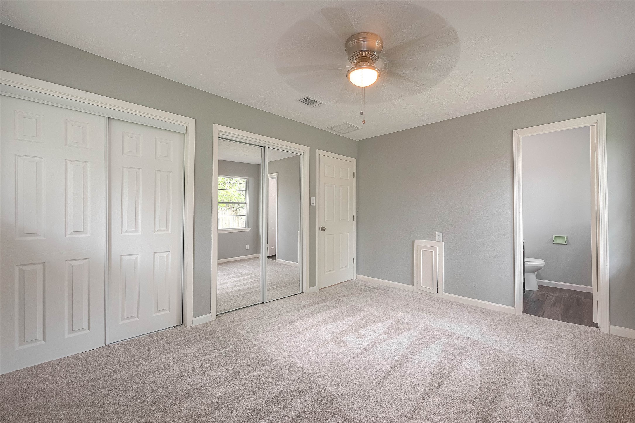 Other view of primary bedroom.