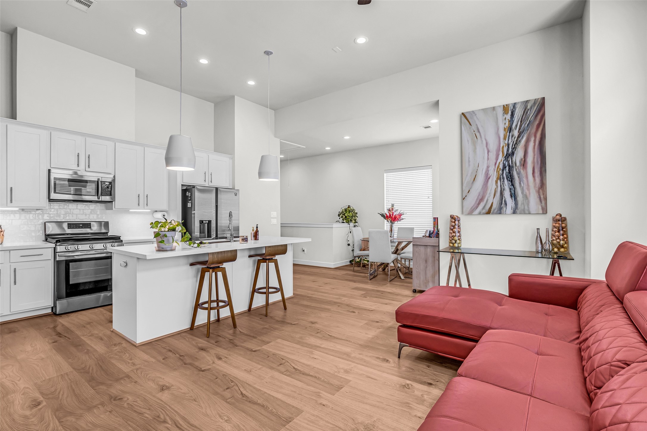 It features an open layout that flows seamlessly into the dining area and living room, creating a connected space for everyday living and entertaining.