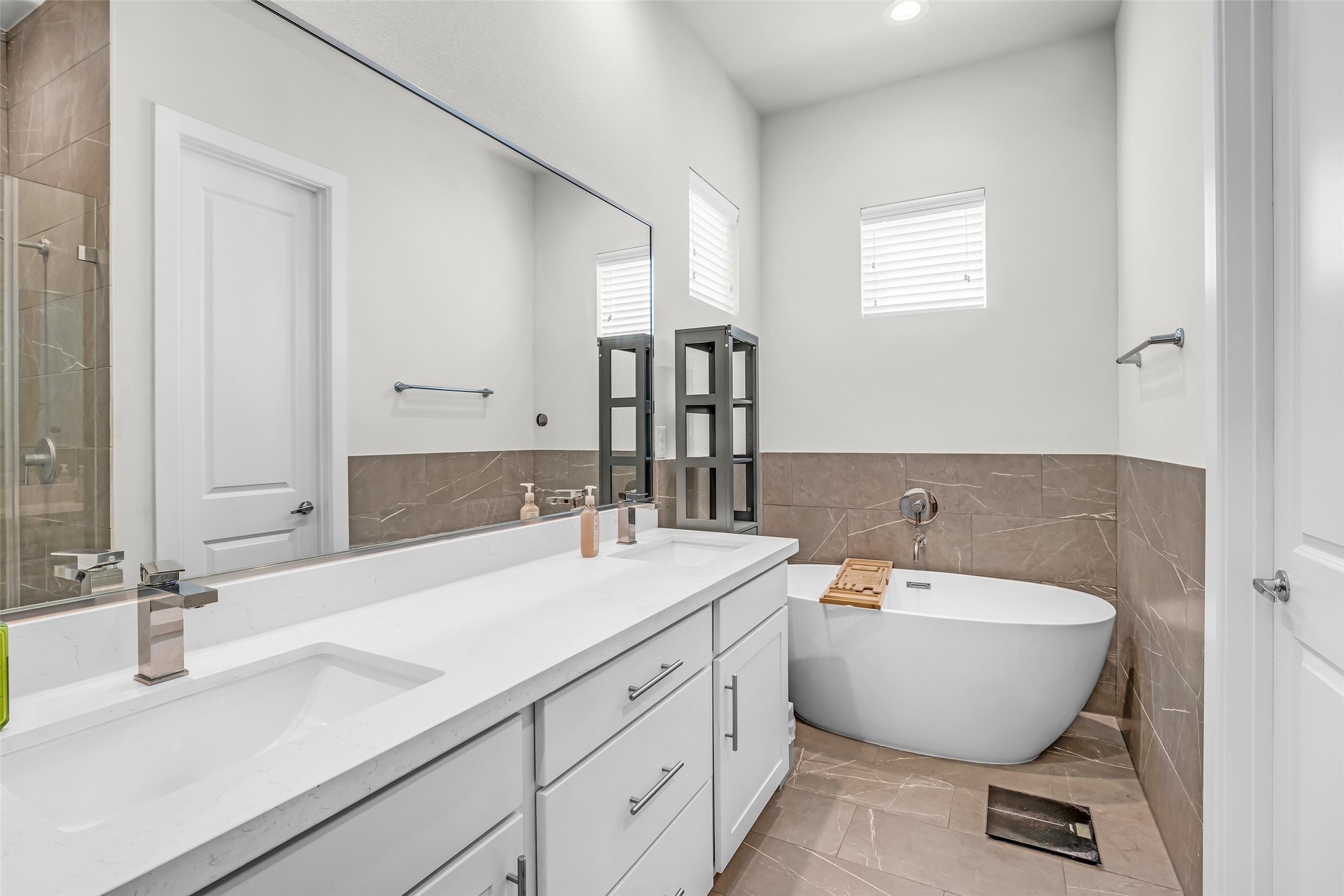 Additional view of the main bathroom highlighting the soaking tub, along with the surrounding finishes and layout of the space.