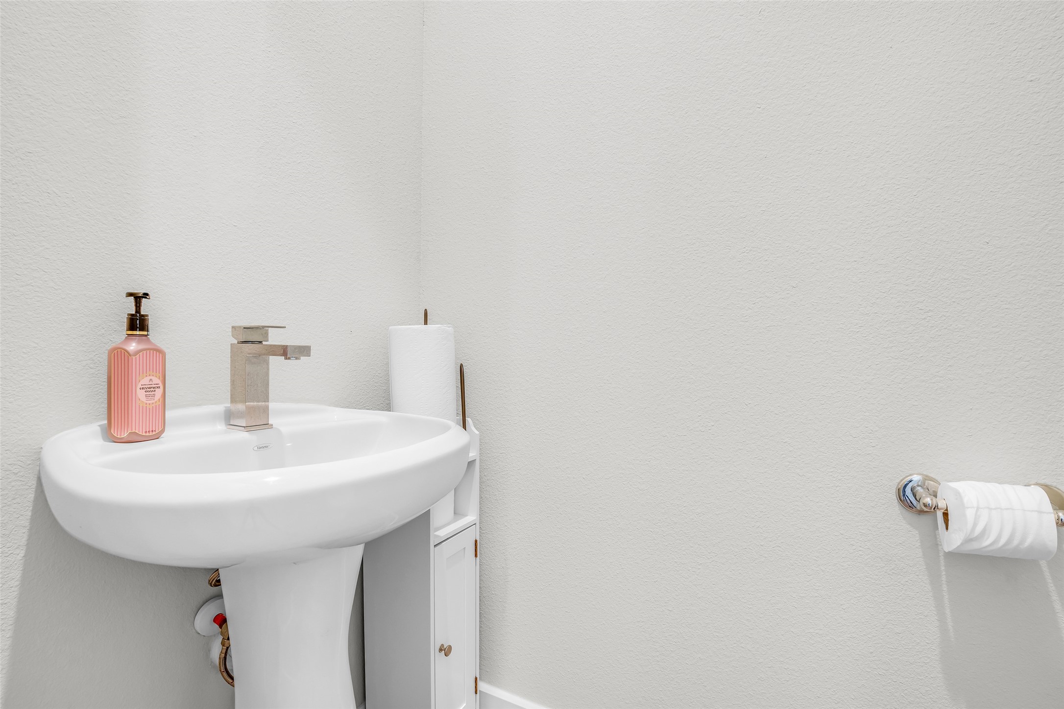 Half bathroom featuring essential fixtures for guests, offering convenience and functionality in a compact space.