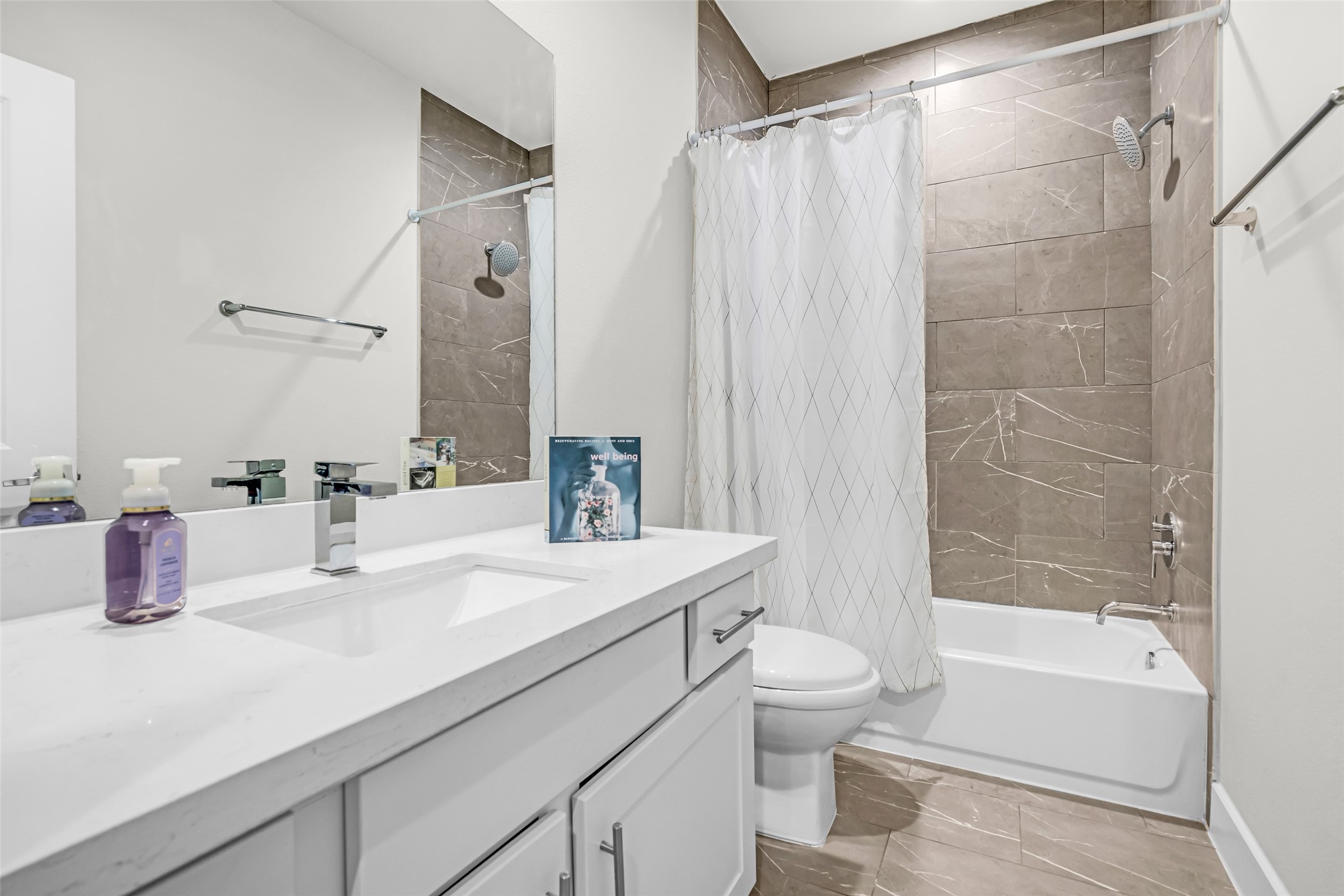 Secondary bathroom featuring a tub and shower combination with modern finishes, providing both style and everyday functionality.