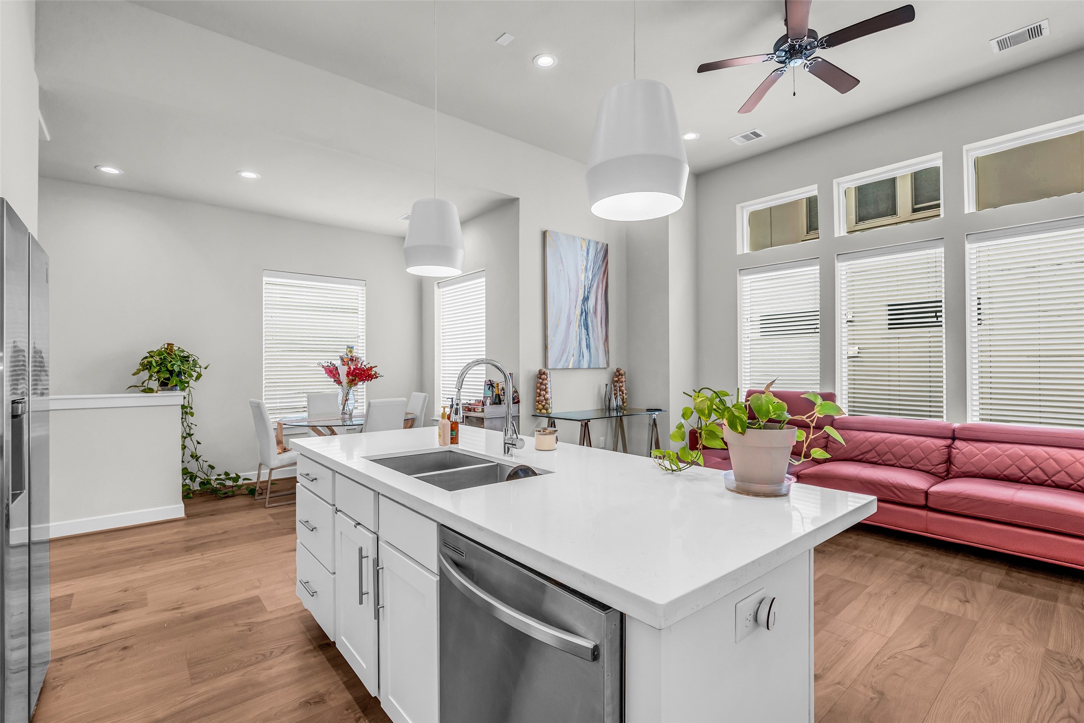 View from the kitchen showing the dining area beside it and the living area directly in front, highlighting the open layout and easy flow between shared spaces.