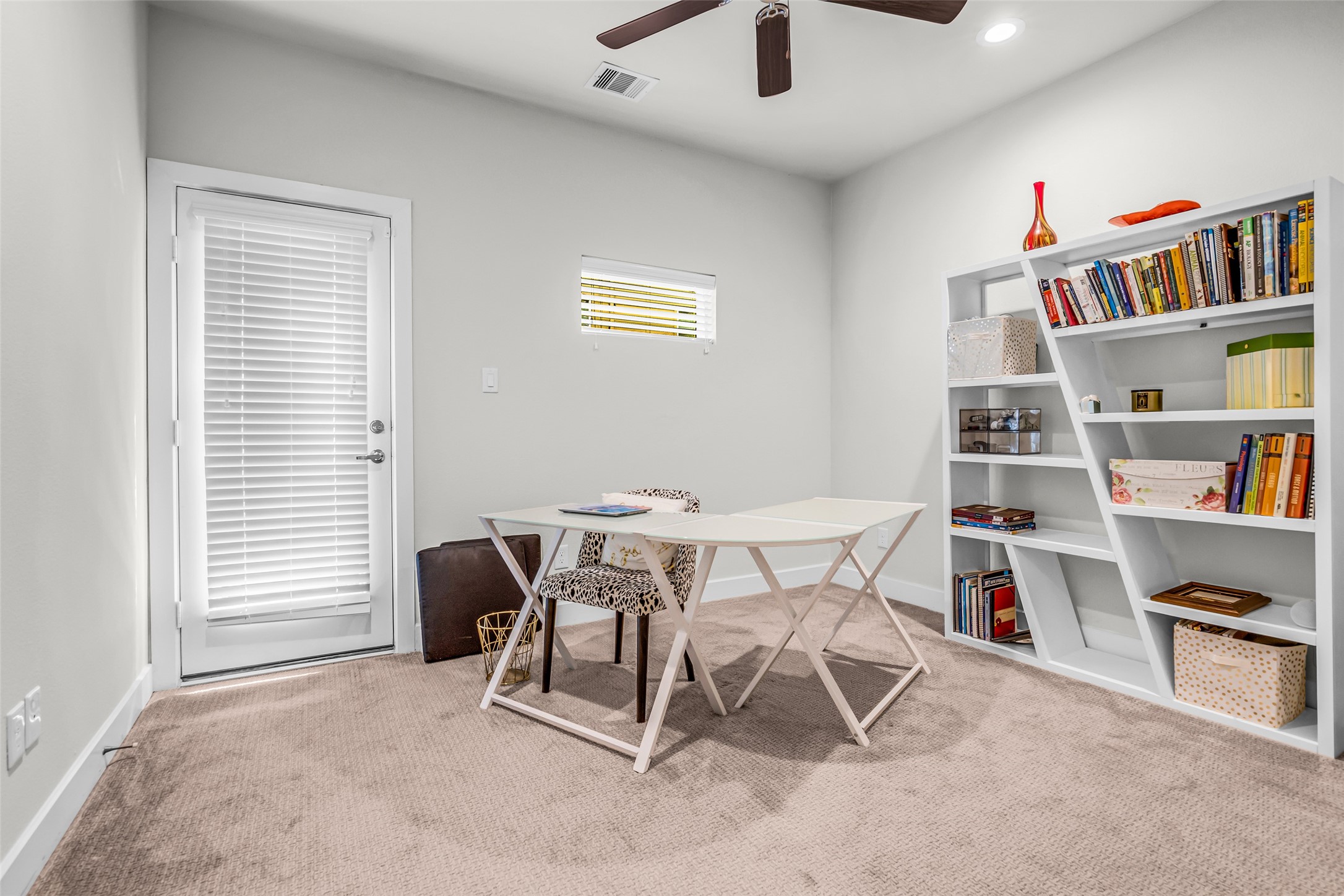 Secondary room featuring a carpeted floor and ceiling fan. This versatile space can serve as a home office, hobby room, workout area, playroom, or guest room to fit your needs.