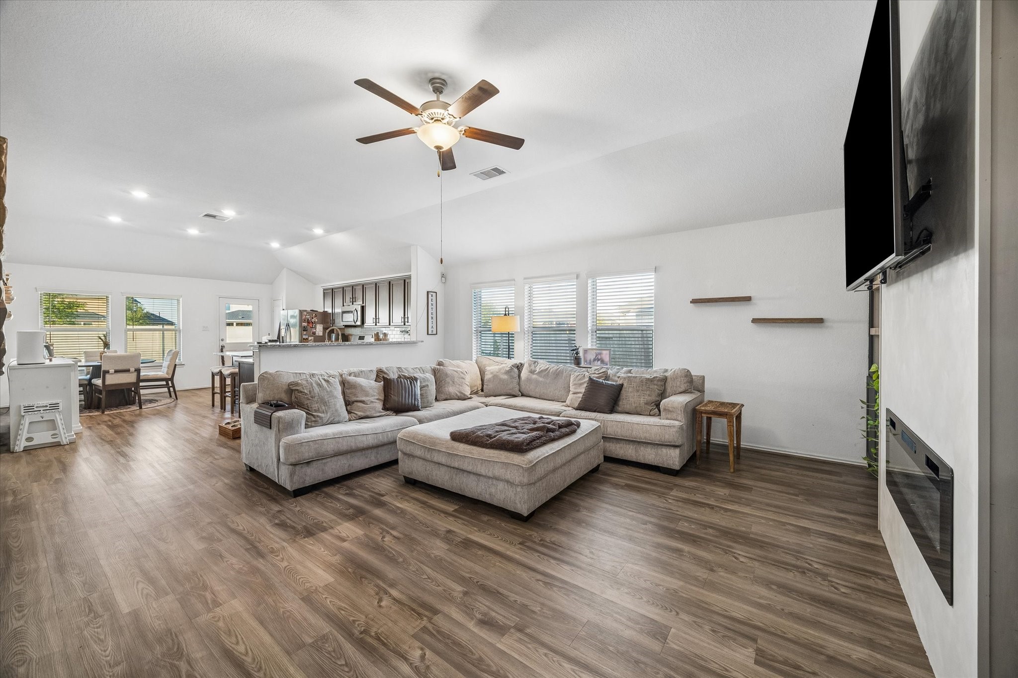 Spacious living area flowing to kitchen