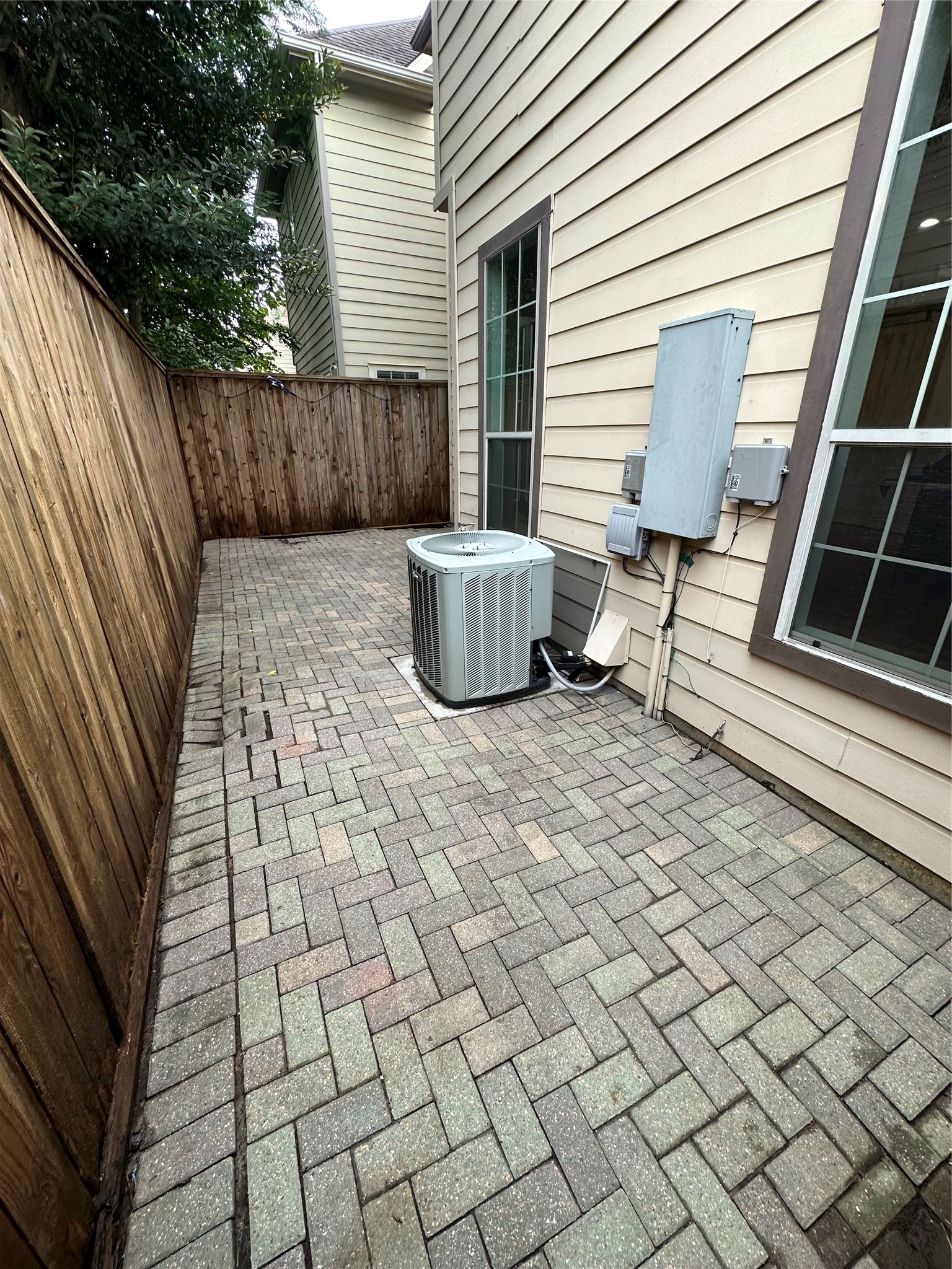 Backyard featuring a herringbone pattern brick.