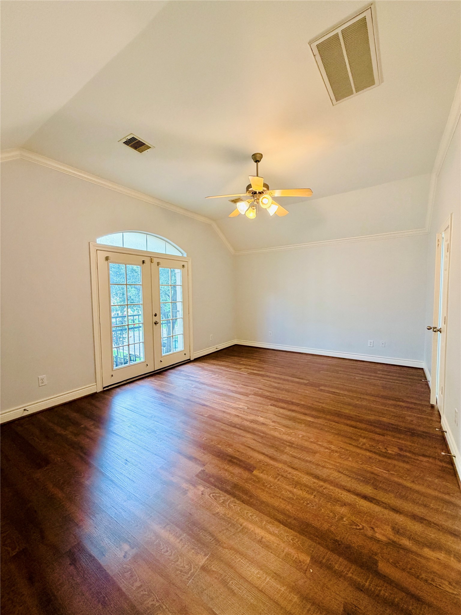 Escape to the expansive primary suite, designed for ultimate relaxation. This generous sized room easily accommodates king-sized furniture with vaulted ceilings and double door windows.