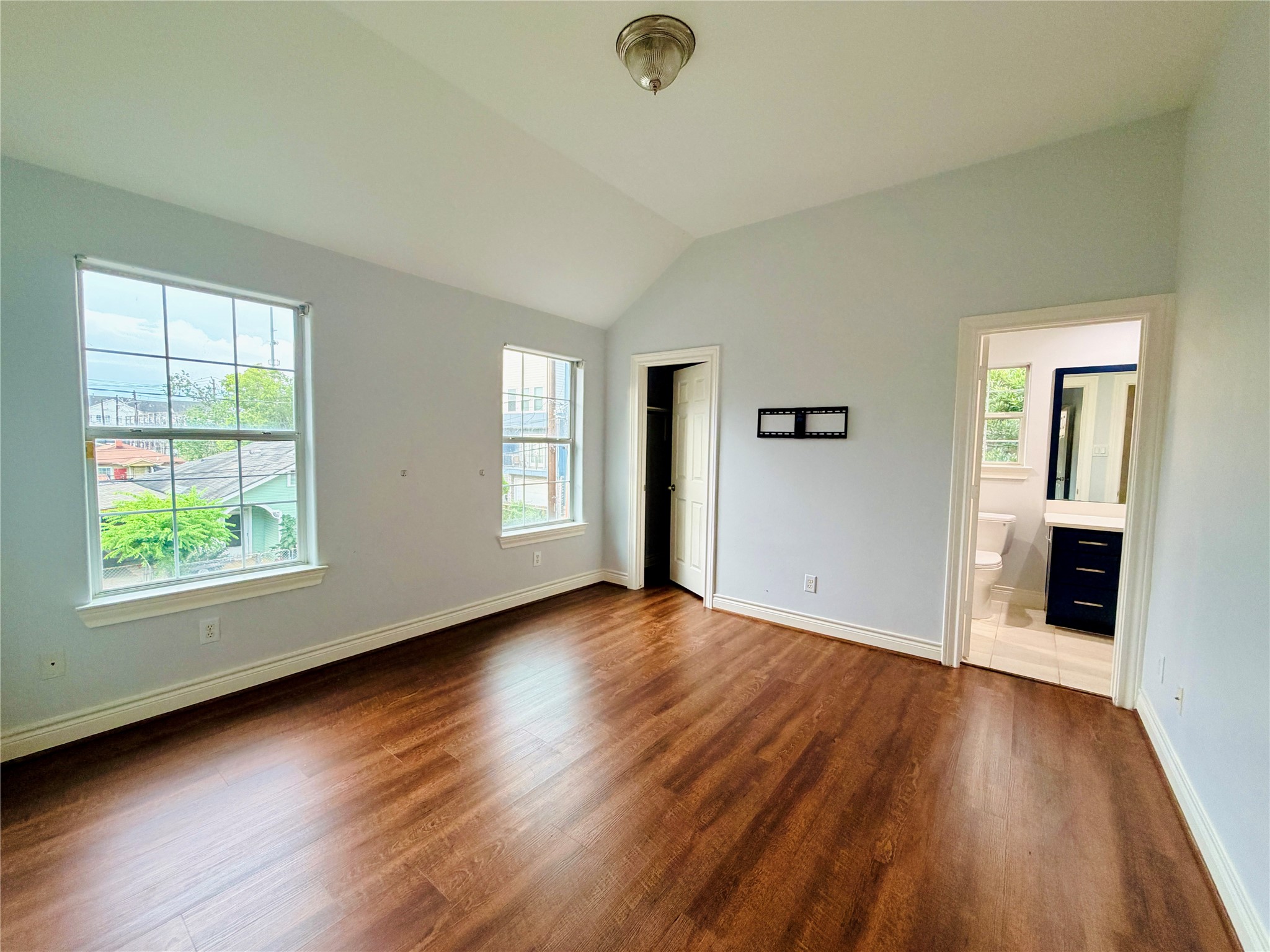 Third bedroom with high ceilings, bright windows, and a walk in closet. Connected to the jack and jill restroom.