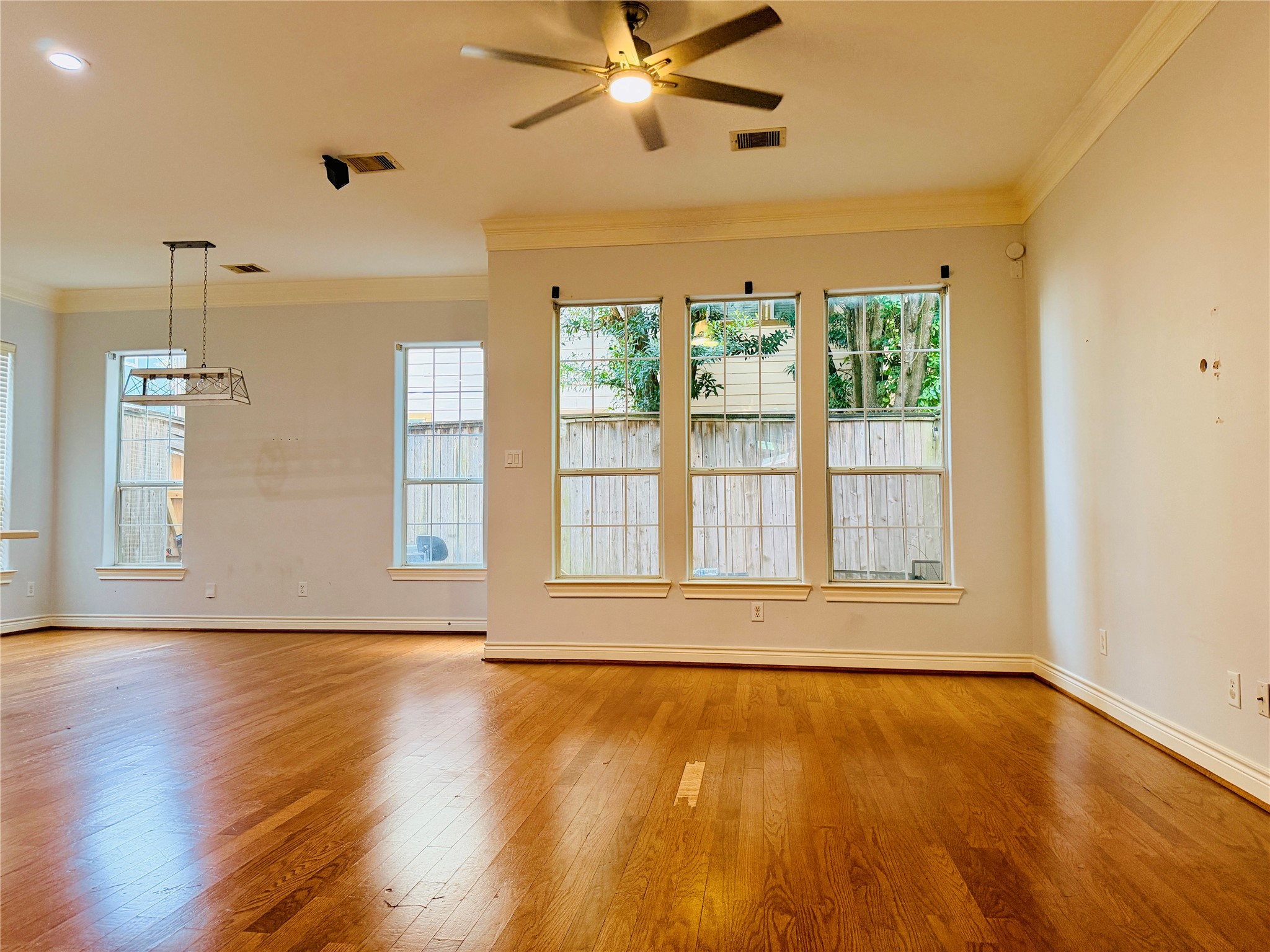 The bright and airy main living space is filled with natural light and large windows.