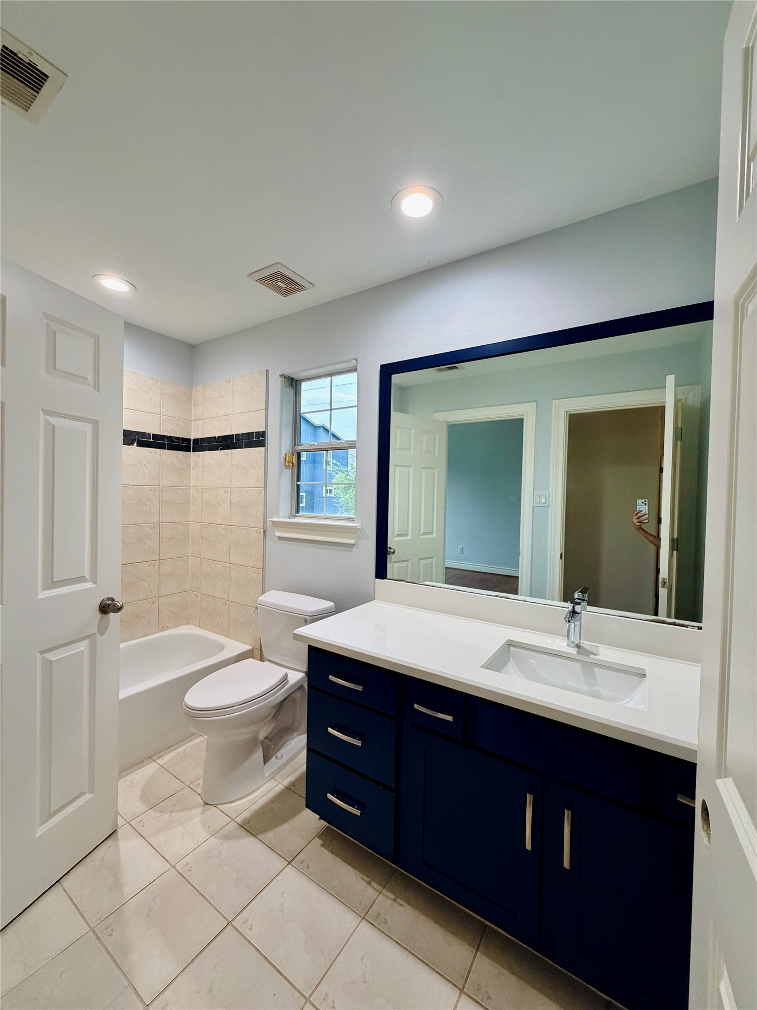 Jack and Jill restroom with a large countertop sink, and bathtub.