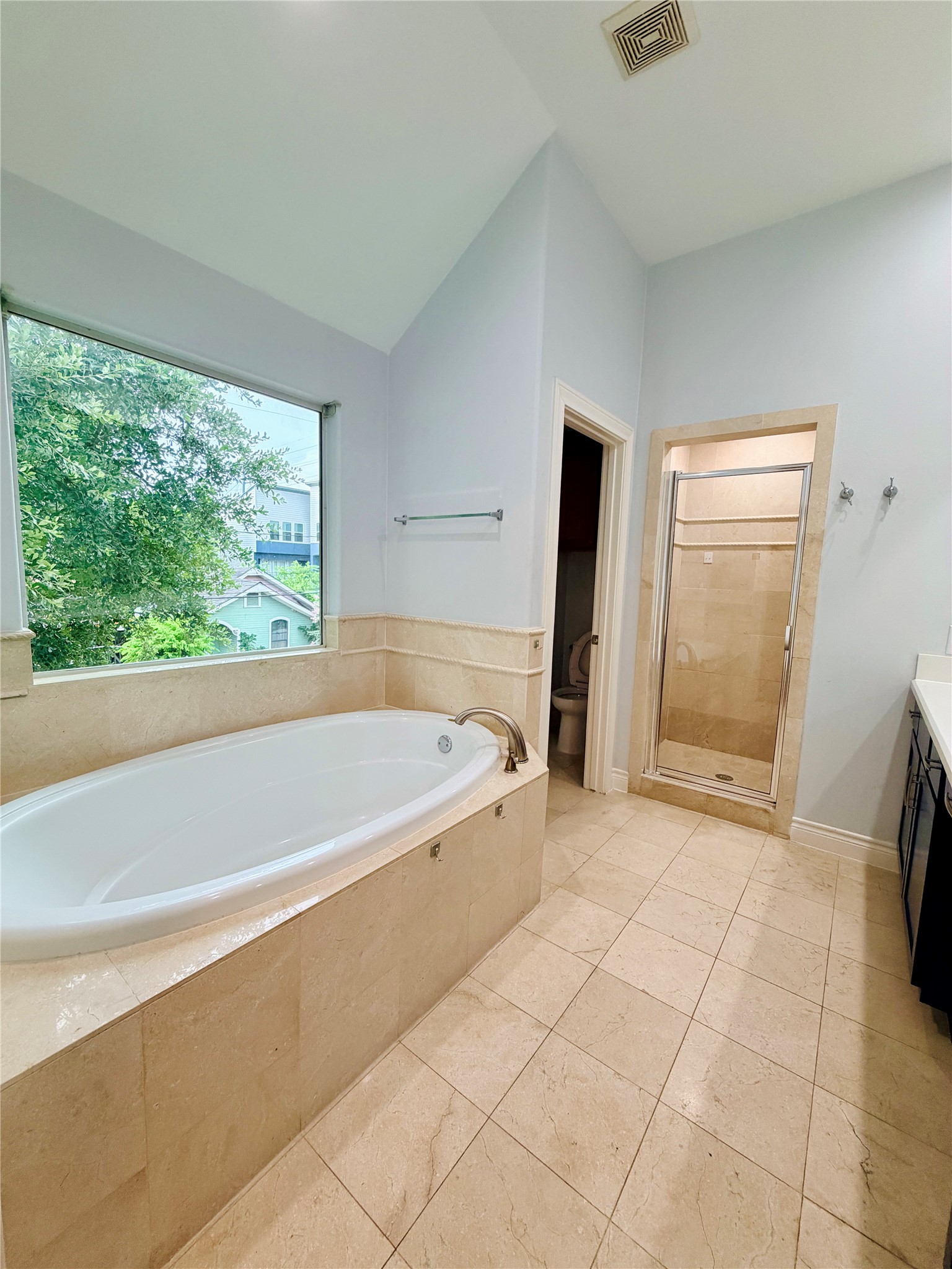 Relax in the spacious soaking tub, beautifully surrounded by elegant tile.