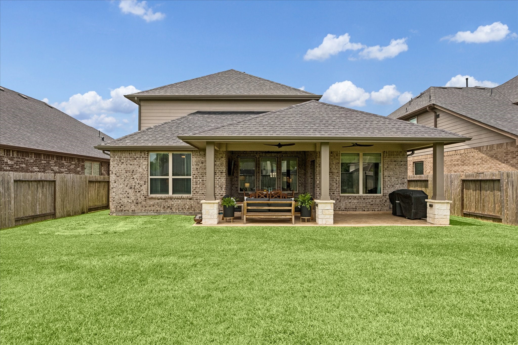Back elevation of the house with back patio addition with ample room to relax, entertain and play.