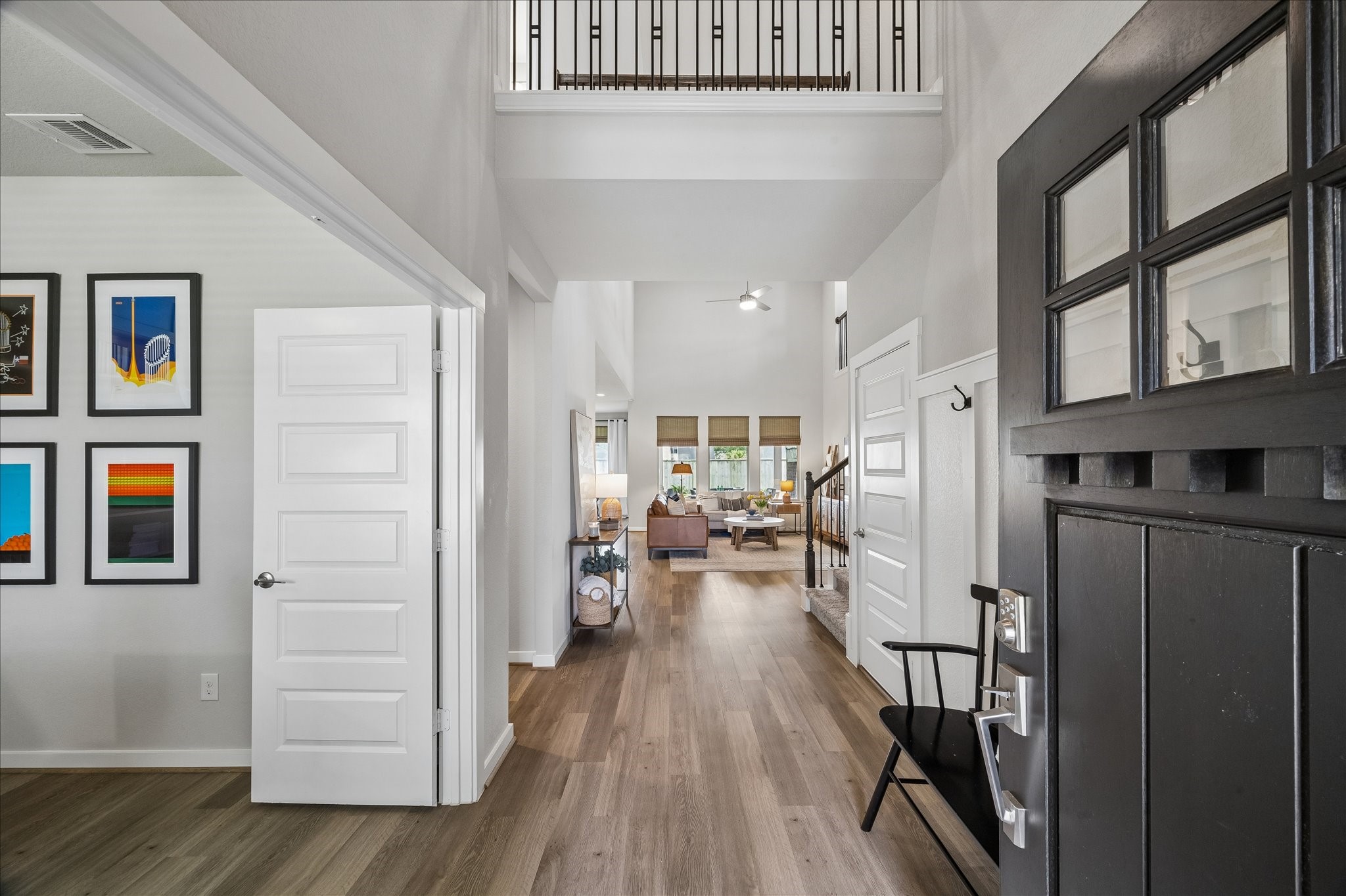 Upon entry you are greeted with soaring ceilings, a second story cat-walk and the study. Thoughtful wainscoting with built-in hooks create a stylish and functional drop zone, adding both charm and everyday convenience to the foyer.