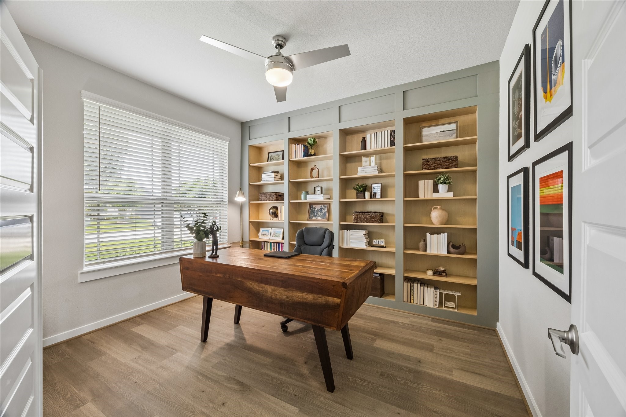 Elegant first floor study filled with natural light, feturing beautiful built-ins and a refined workspace.