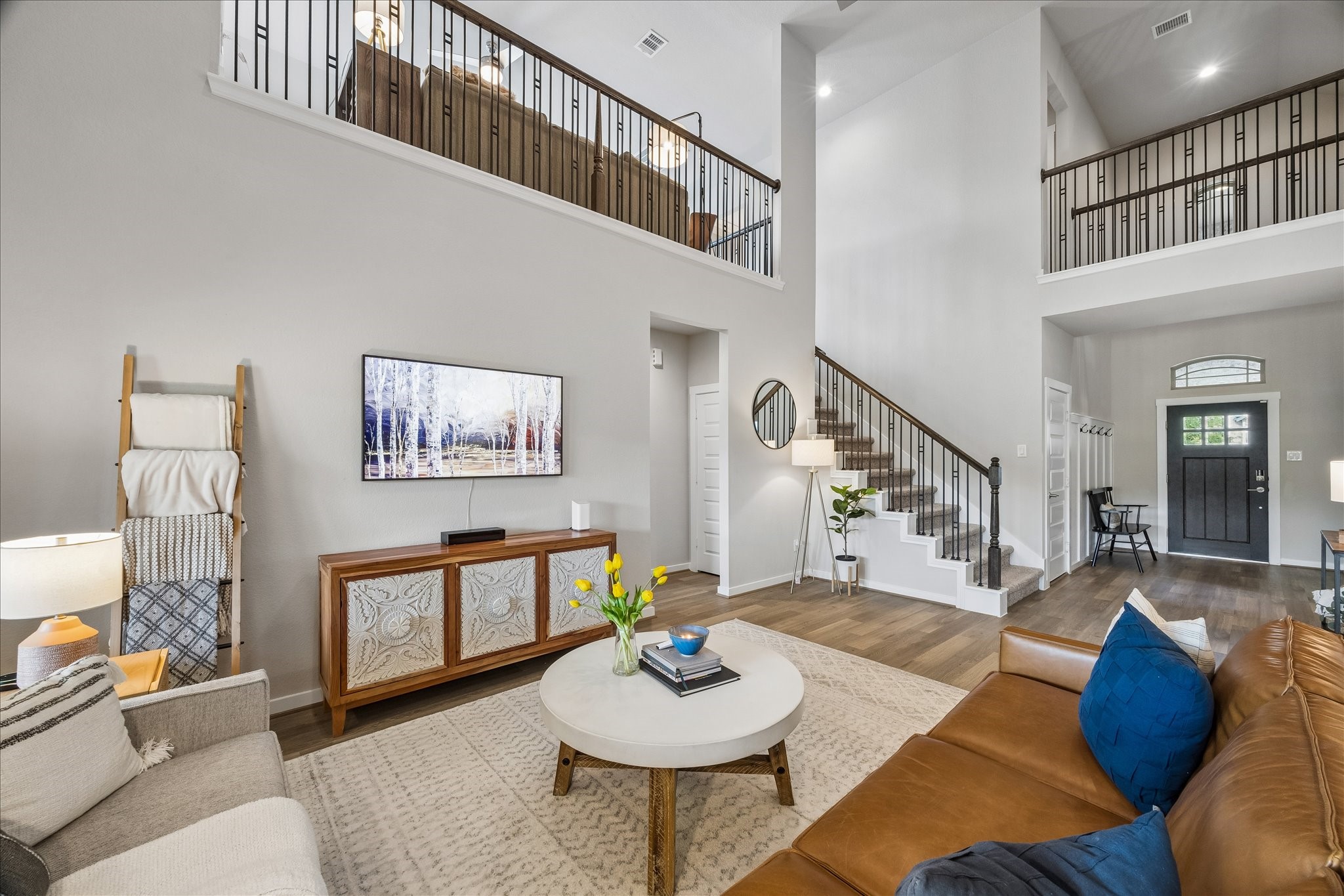 View of the open concept living room and second floor game room.