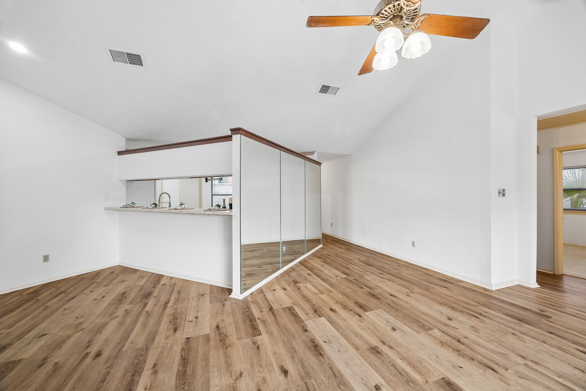 Kitchen provides a breakfast bar as well as access to the formal dining attached to the living space.