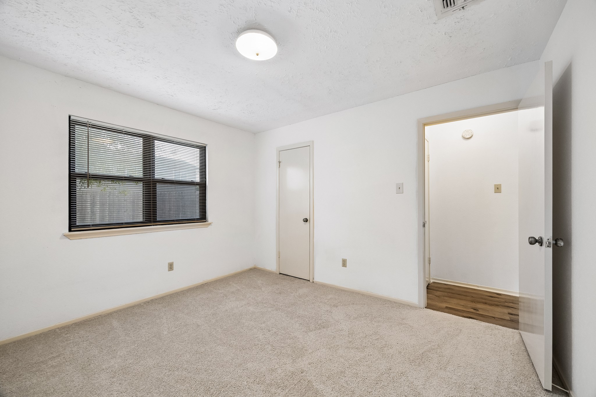 Secondary bedroom 1 has new carpet and walk-in closet.