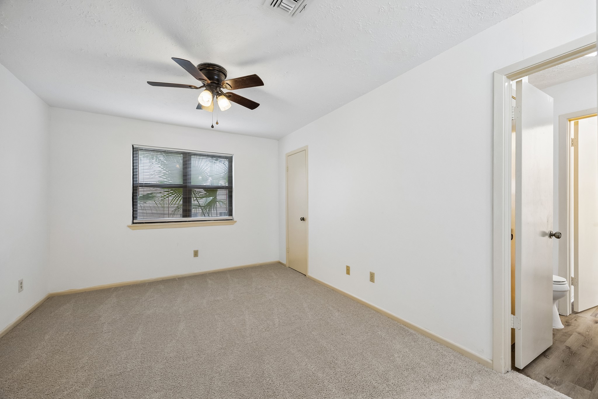 Secondary bedroom 2 has easy access to the secondary bathroom as well as new carpet and walk-in closet and ceiling fan.