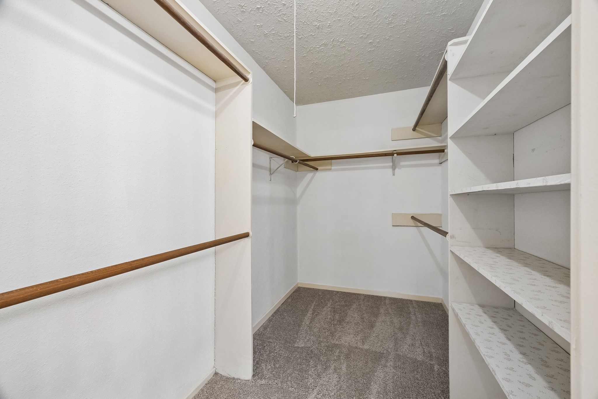 HUGE walk-in closet in the primary bedroom provides varied level hanging rods and shelves too!