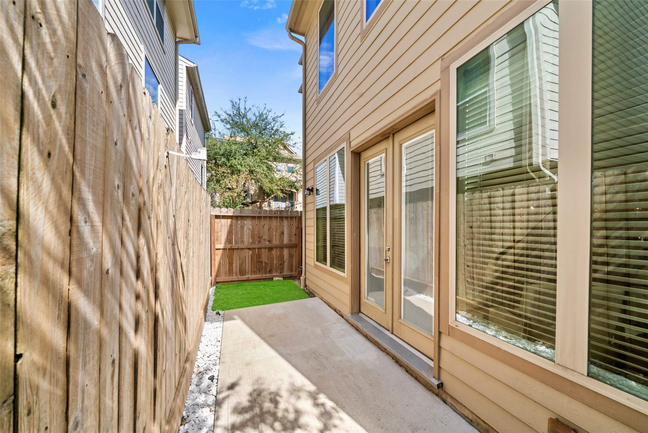 Back patio with synthetic turf is easy living at its best.