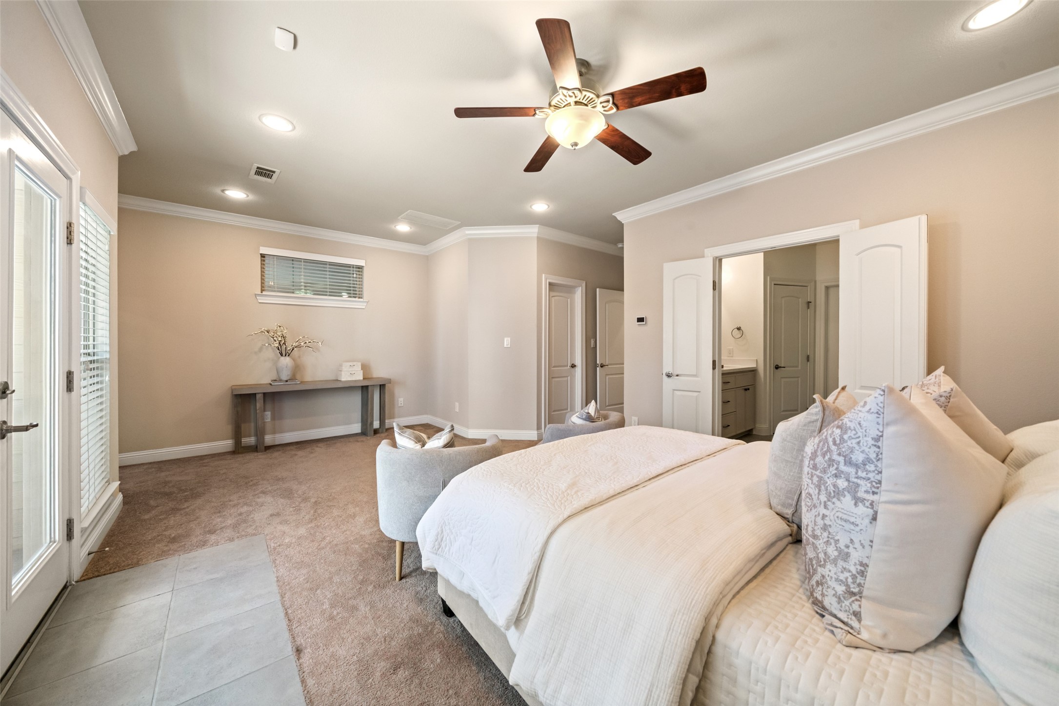 Alternate view of primary suite with primary bath on right. Door at entry is the secondary walk-in closet.