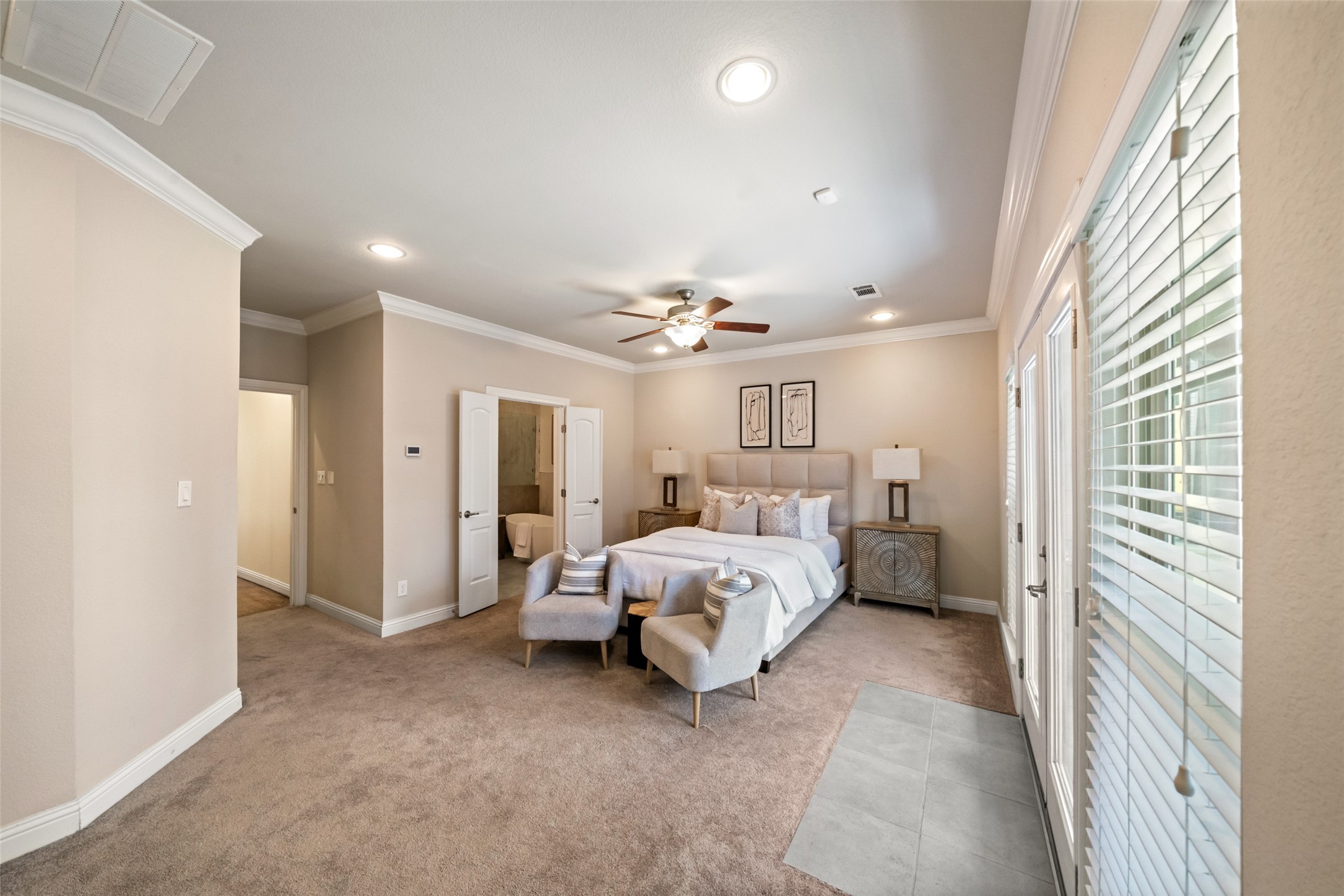 The primary bedroom is spacious with plenty space for large furnishings.