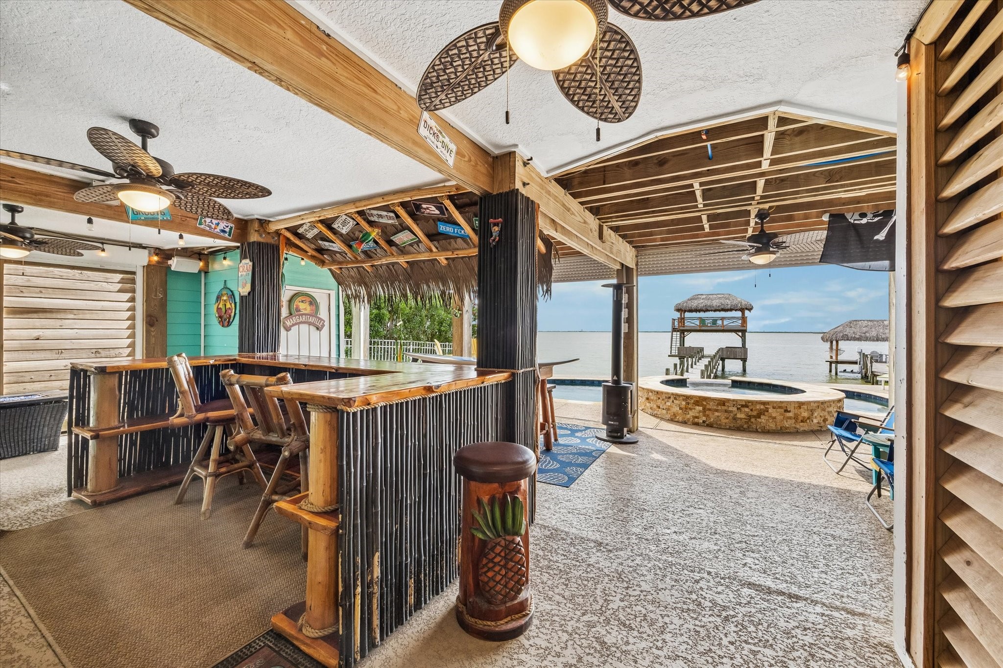 THE WATERFRONT ELEVATION SHOWCASES EXPANSIVE BALCONIES, A COVERED ENTERTAINING AREA, AND DIRECT ACCESS TO THE PRIVATE PIER.