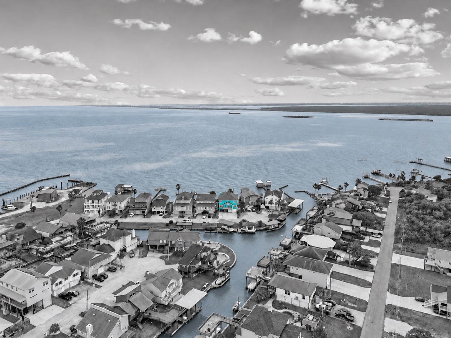 WATERFRONT LOCATION WITH DIRECT CANAL ACCESS AND EXPANSIVE VIEWS OF GALVESTON BAY. THE HIGHLIGHTED HOME SITS JUST STEPS FROM OPEN WATER.