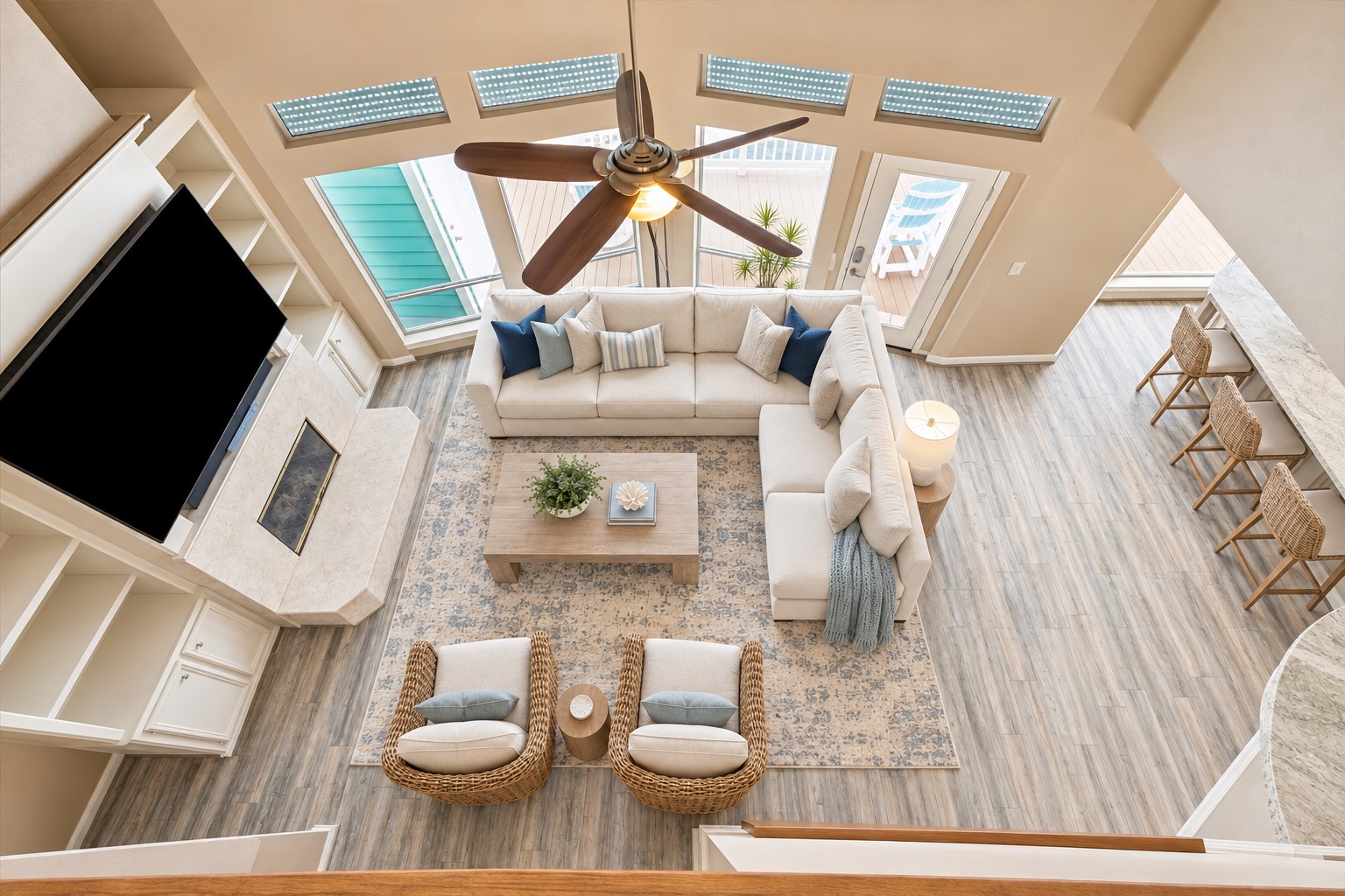 THIS OVERHEAD VIEW HIGHLIGHTS THE OPEN LAYOUT, FIREPLACE, BREAKFAST BAR, AND DIRECT CONNECTION TO THE WATERFRONT BALCONY. **Virtually Staged