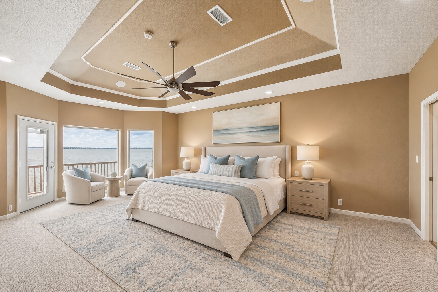 THE SPACIOUS PRIMARY SUITE FEATURES A MULTILEVEL TRAY CEILING, RECESSED LIGHTING, LARGE WATER-FACING WINDOWS, AND PRIVATE BALCONY ACCESS. **Virtually Staged.