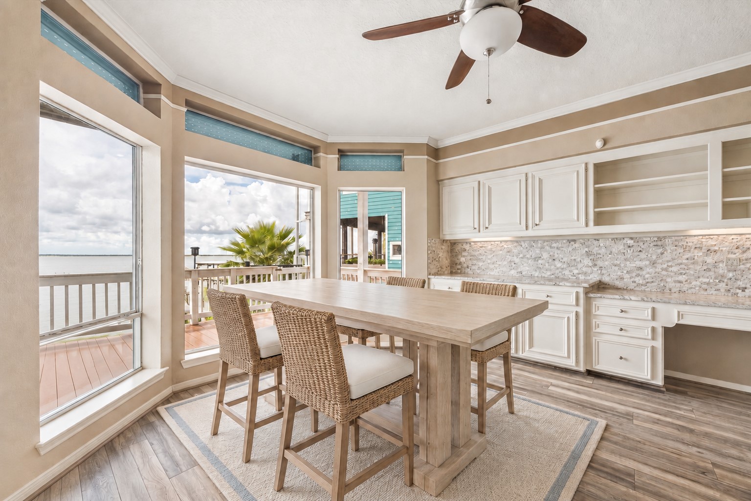 THE KITCHEN OFFERS ABUNDANT CABINETRY, EXTENSIVE COUNTER SPACE, AND LARGE WINDOWS WITH DIRECT WATER VIEWS. **Virtually Staged.