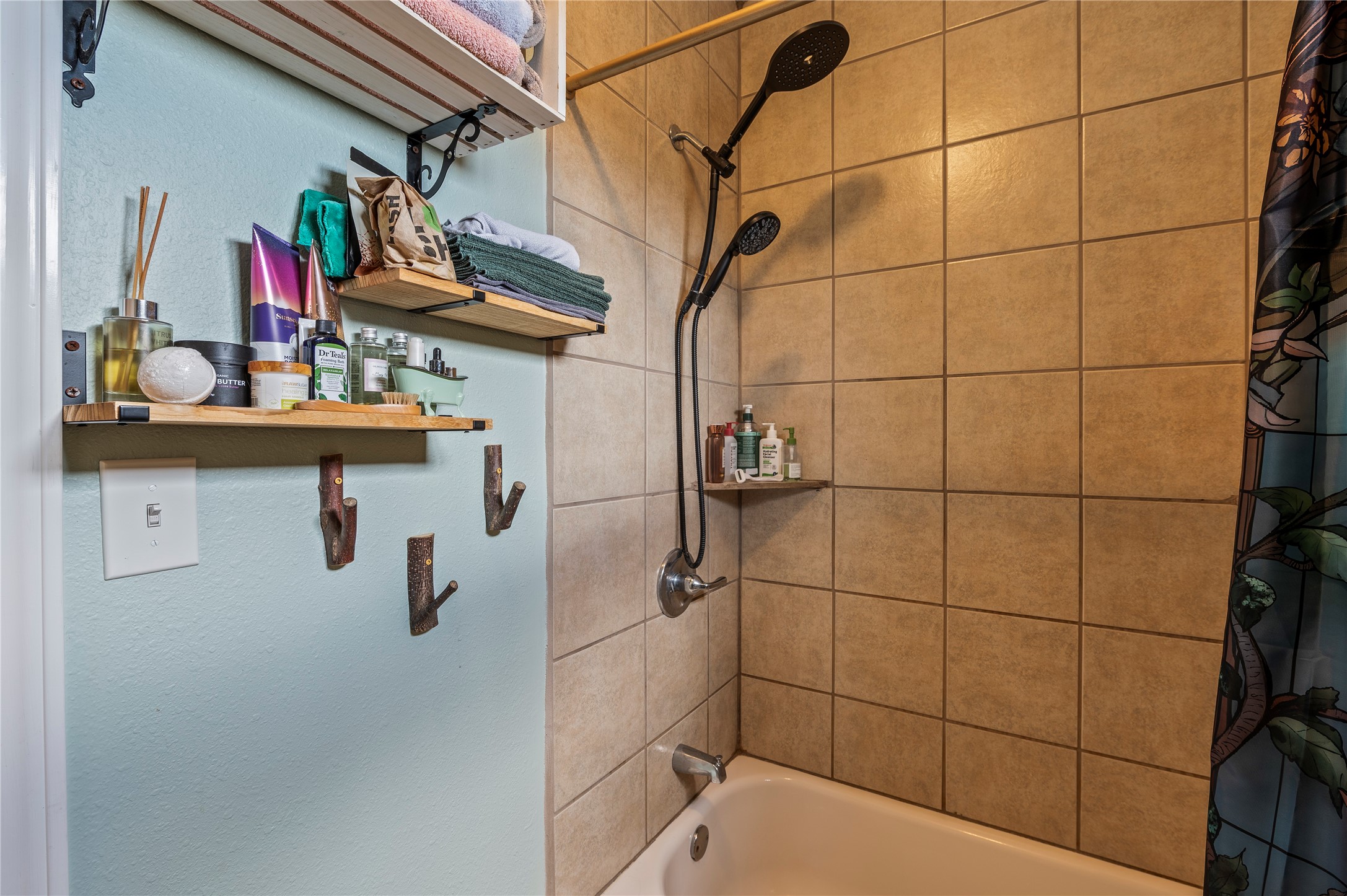 Tiled shower/tub combo in the primary bath.