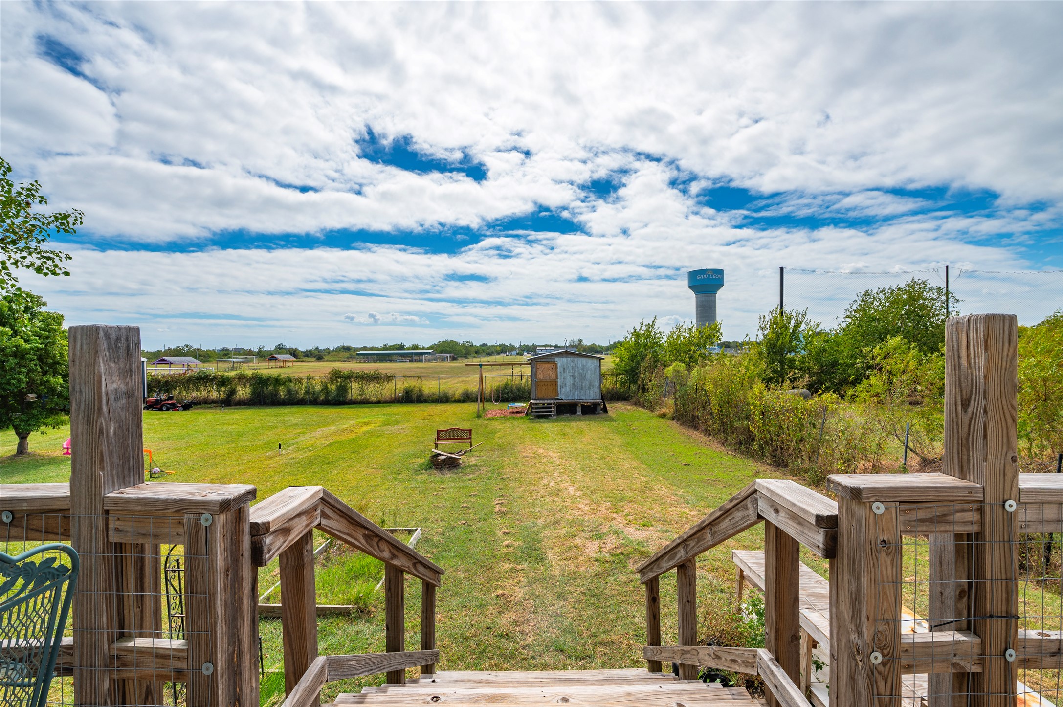 Wooden staircases leads down the back yard of the property.
