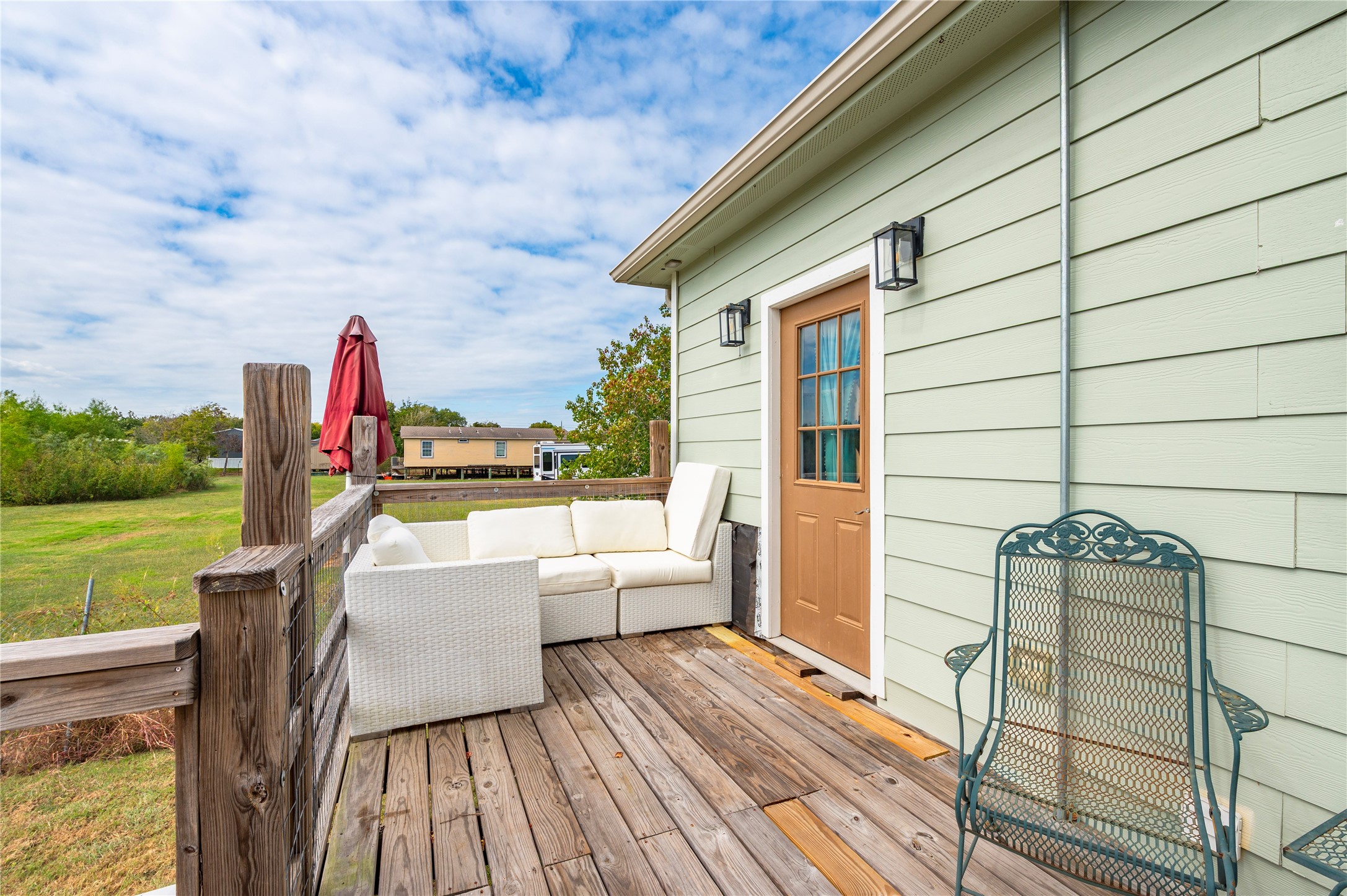 Wooden back deck with views into the surrounding fields.