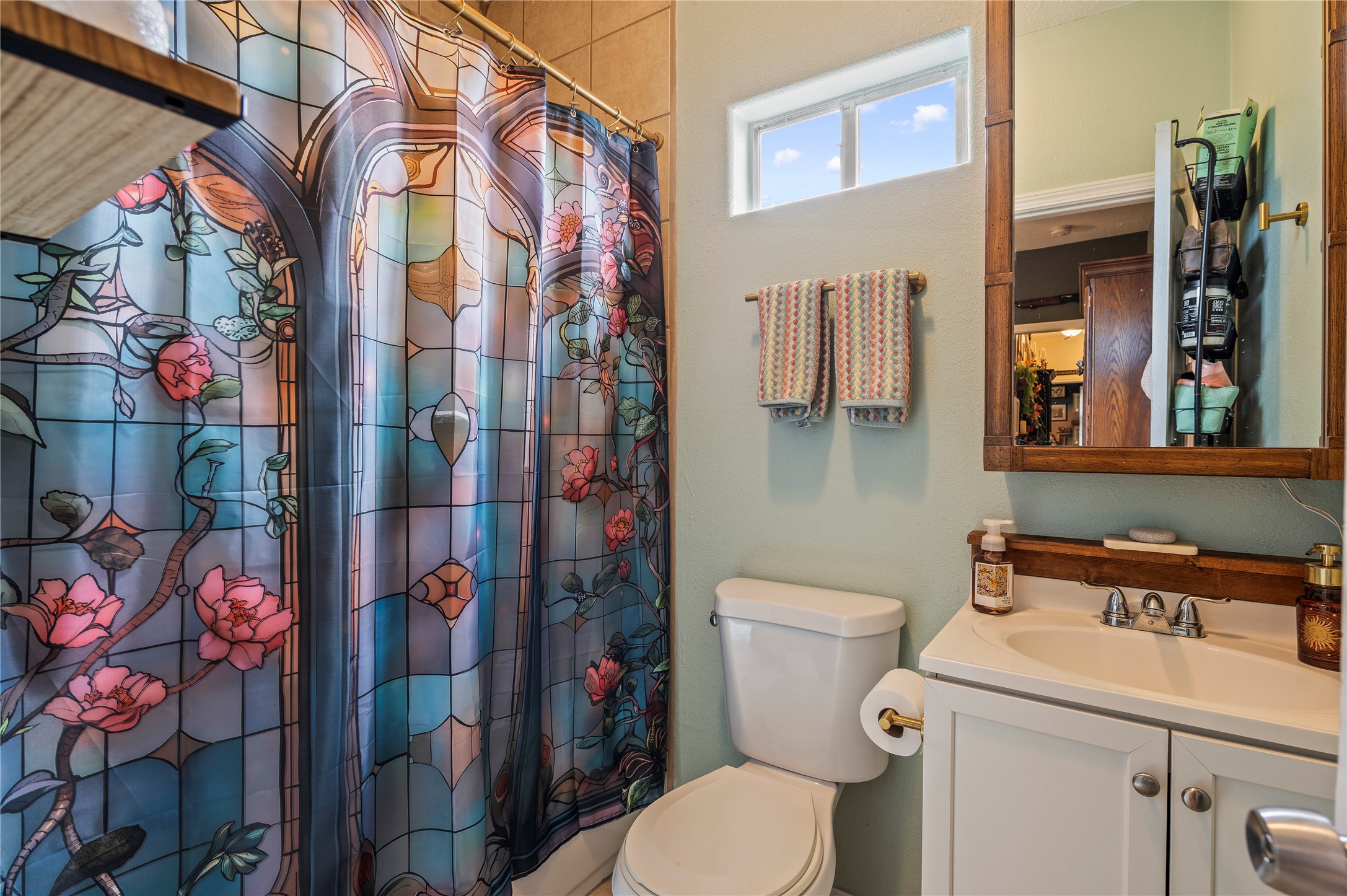 Primary bath with vanity and shower/tub combo.