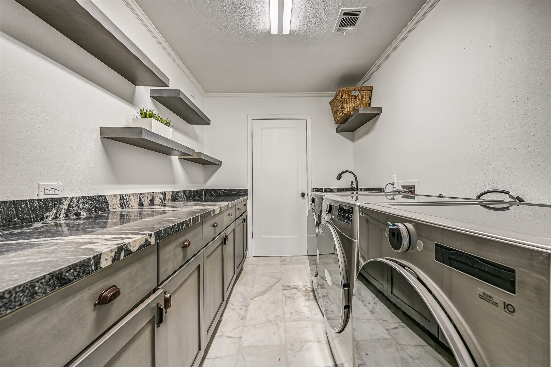 A home that welcomes a crowd needs practical spaces that can keep up. Extensive cabinetry and generous work surfaces help make busy weekends easier to manage.