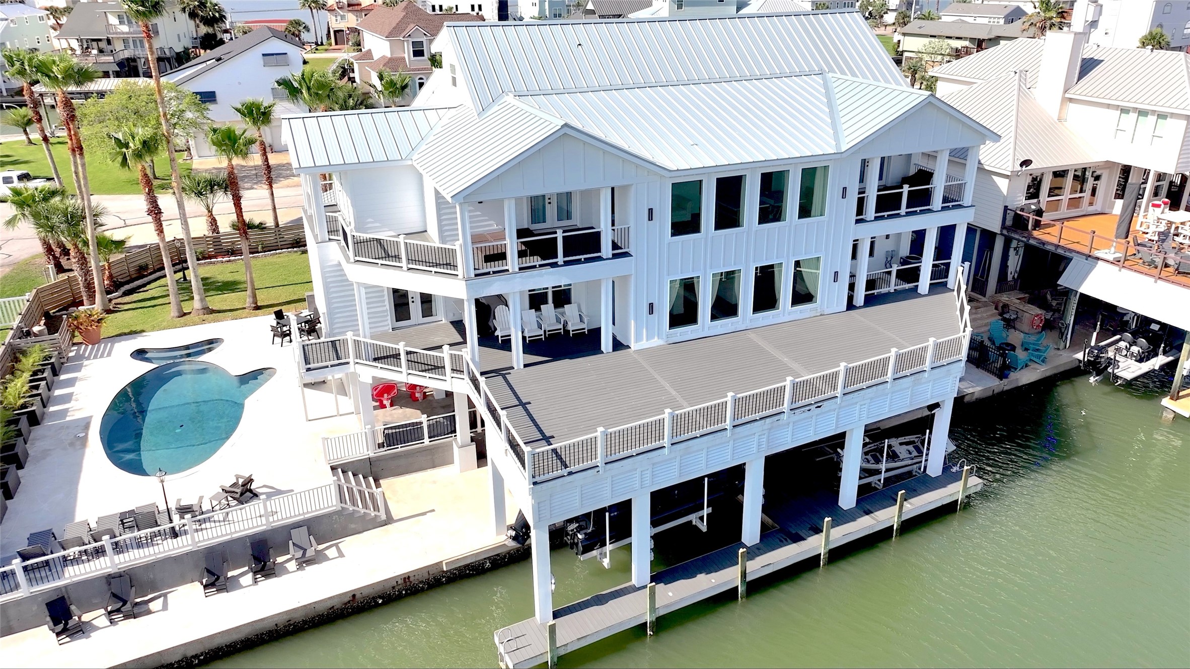 The pool, expansive decks and canal come together to create a waterfront playground at home. Imagine friends arriving by boat, afternoons by the pool and dinners outside with everyone you love. The pool, expansive decks and canal come together to create a waterfront playground at home. Imagine friends arriving by boat, afternoons by the pool and dinners outside with everyone you love.