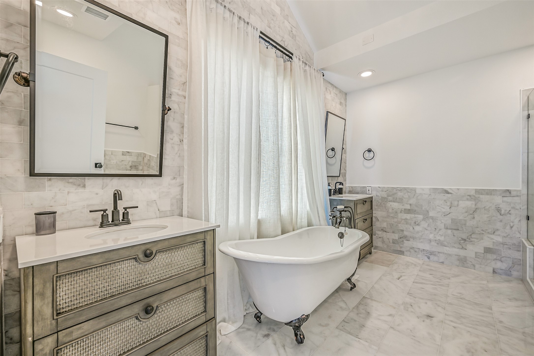 A freestanding clawfoot tub gives this ensuite plenty of personality. Guests have their own comfortable space to unwind at the end of the day.