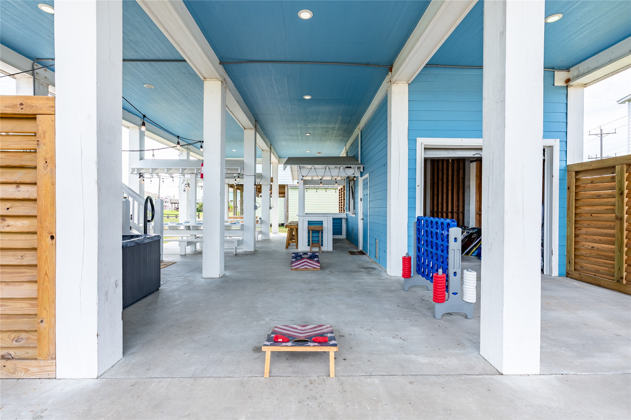 Game days happen right at home with a spacious covered entertaining area ready for cornhole, gatherings, and laid-back fun.