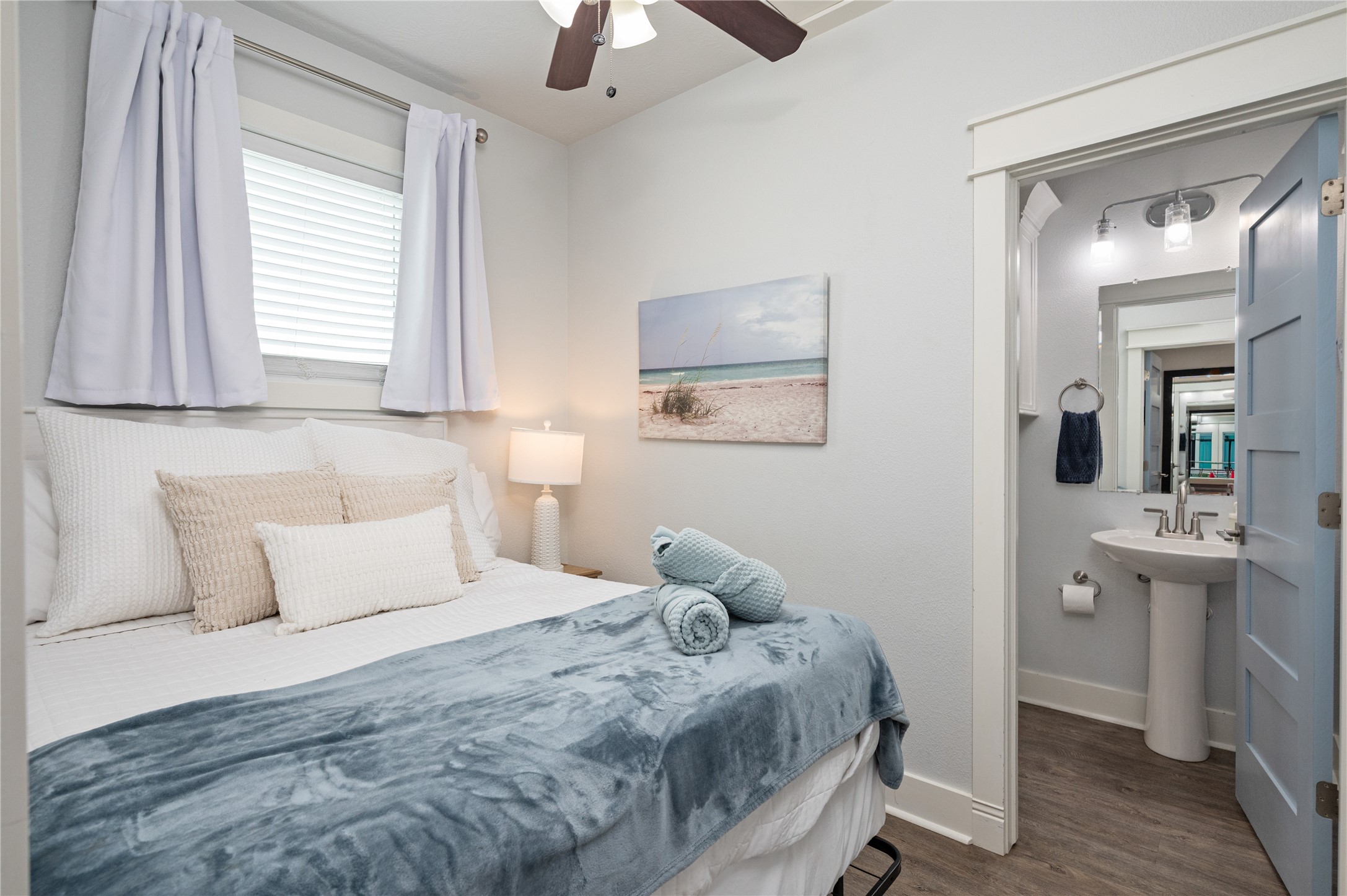 Settle into a cozy bedroom retreat with soft coastal styling and the convenience of an adjoining private bath.