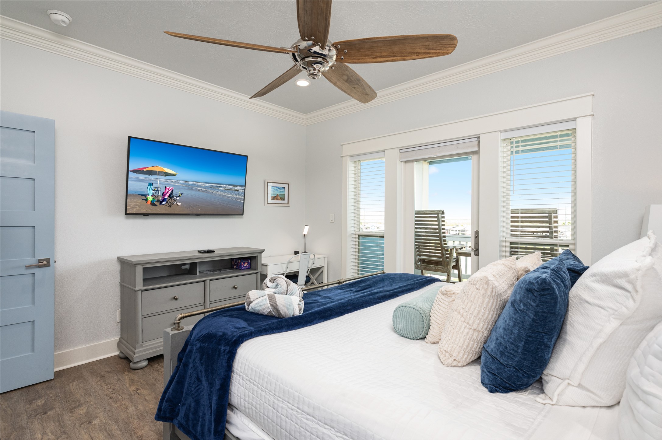 Wake up to natural light in this inviting bedroom, then step directly onto the covered balcony for a quiet start to the day.