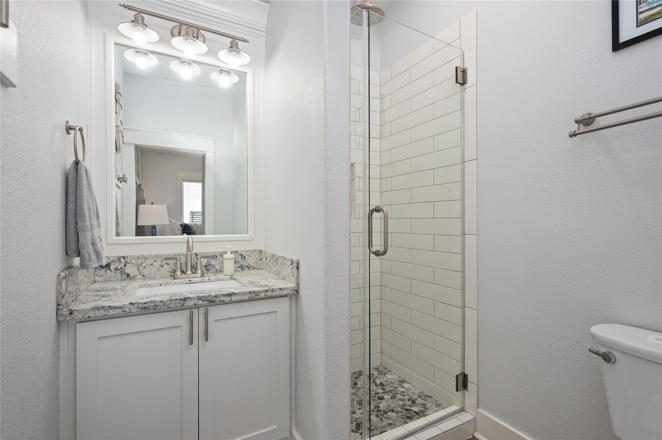 Getting ready feels effortless with a granite-topped vanity and a bright walk-in shower just steps from the bedroom.