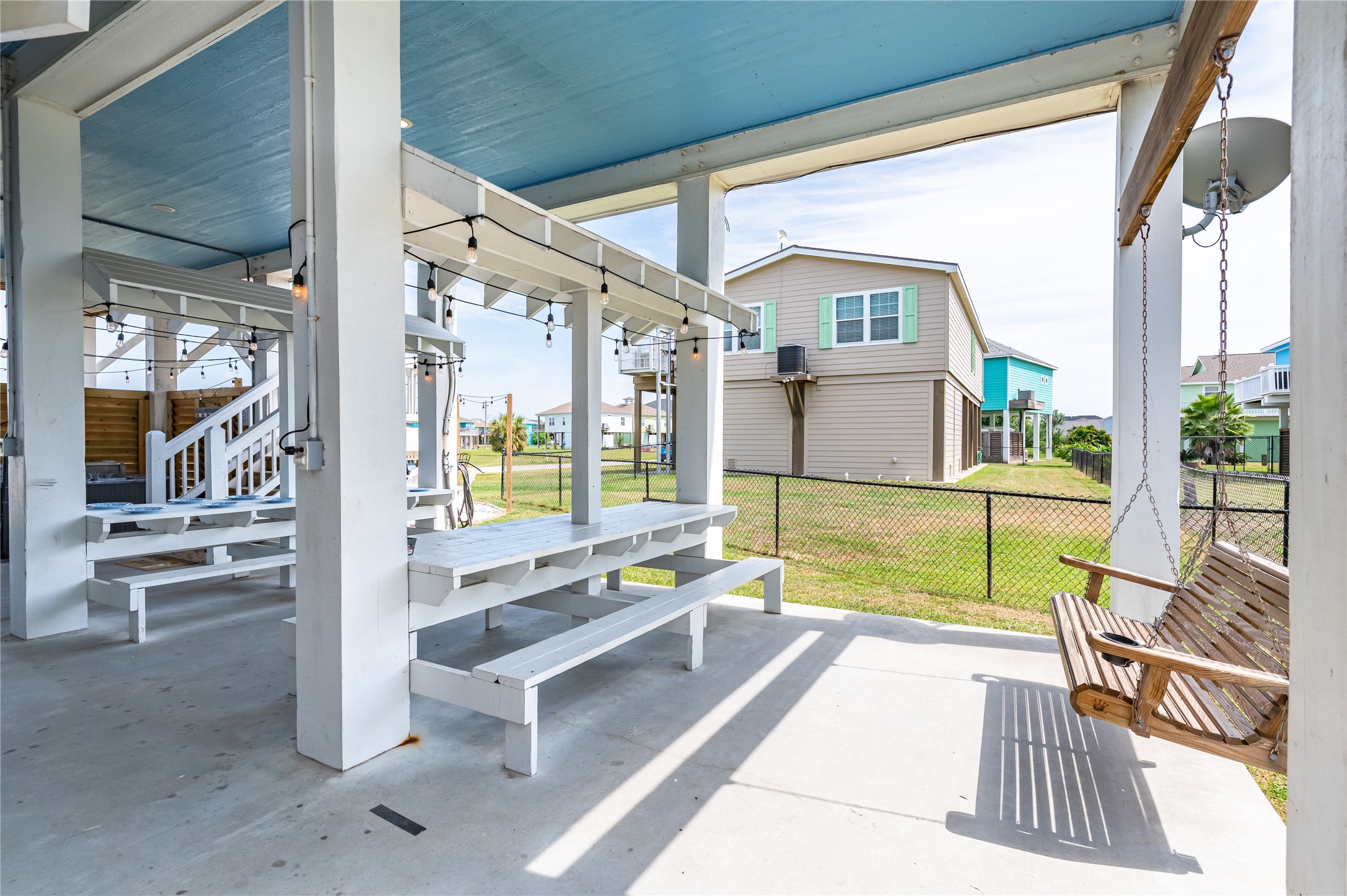 Lazy afternoons feel right at home in your shaded outdoor retreat, complete with picnic-table seating, a porch swing, and plenty of room to gather.