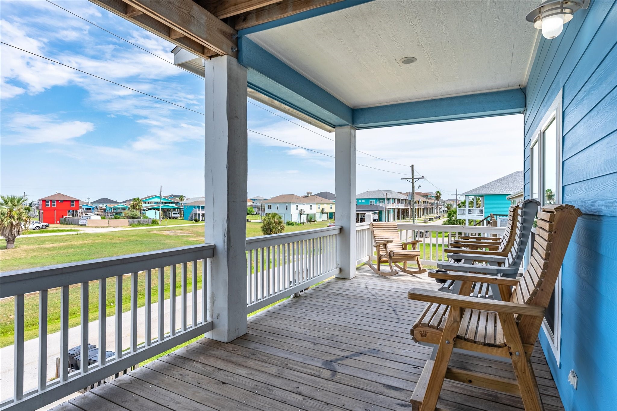 Mornings start easy on your covered balcony, rocking with a cup of coffee while the coastal neighborhood wakes up around you.