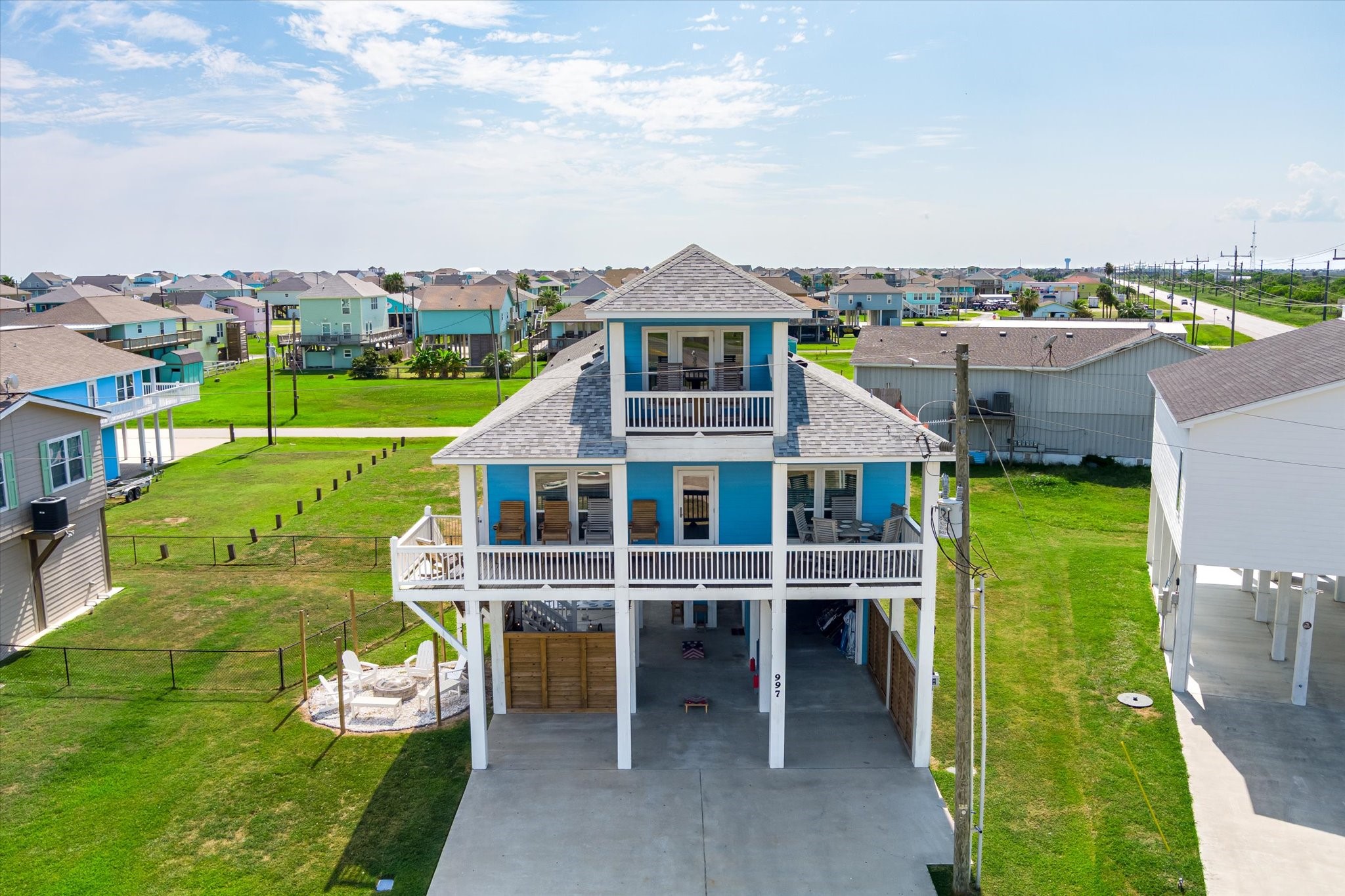 Theres no mistaking your beach house with its cheerful blue exterior, expansive covered balcony, and elevated coastal design.