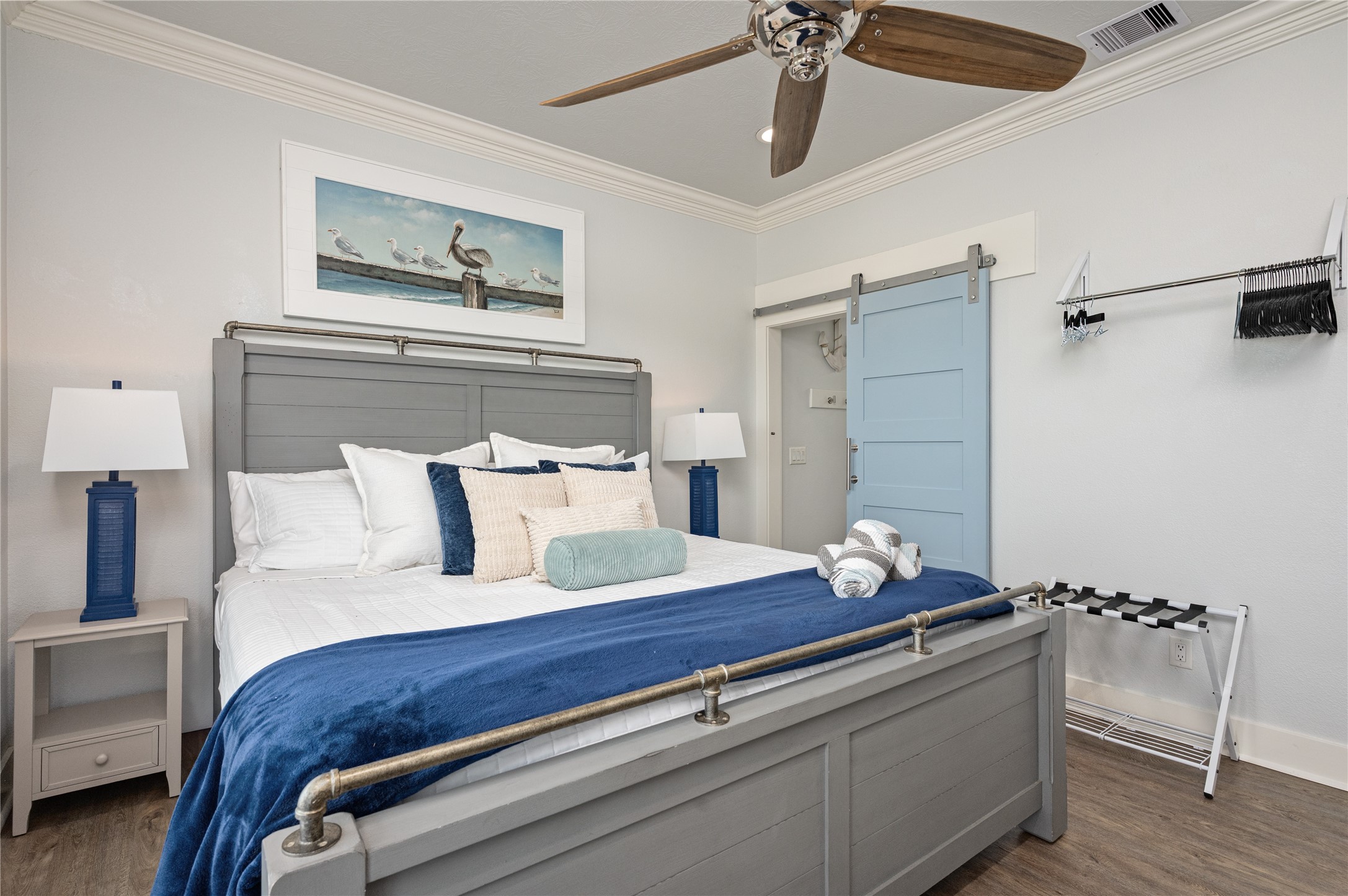 Unwind in a comfortable bedroom with coastal touches, a ceiling fan, and a space that feels tucked away from the main living areas.