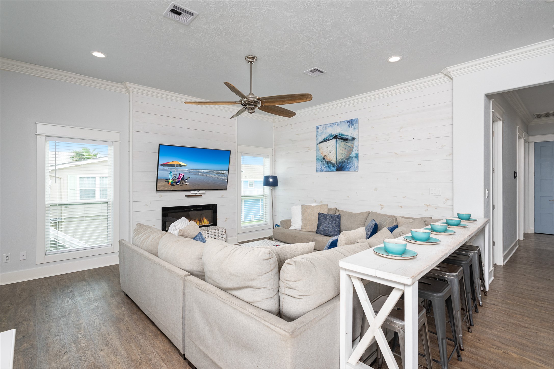 Settle into your inviting living room, where generous seating, coastal touches, and the fireplace create an easy place to unwind together.