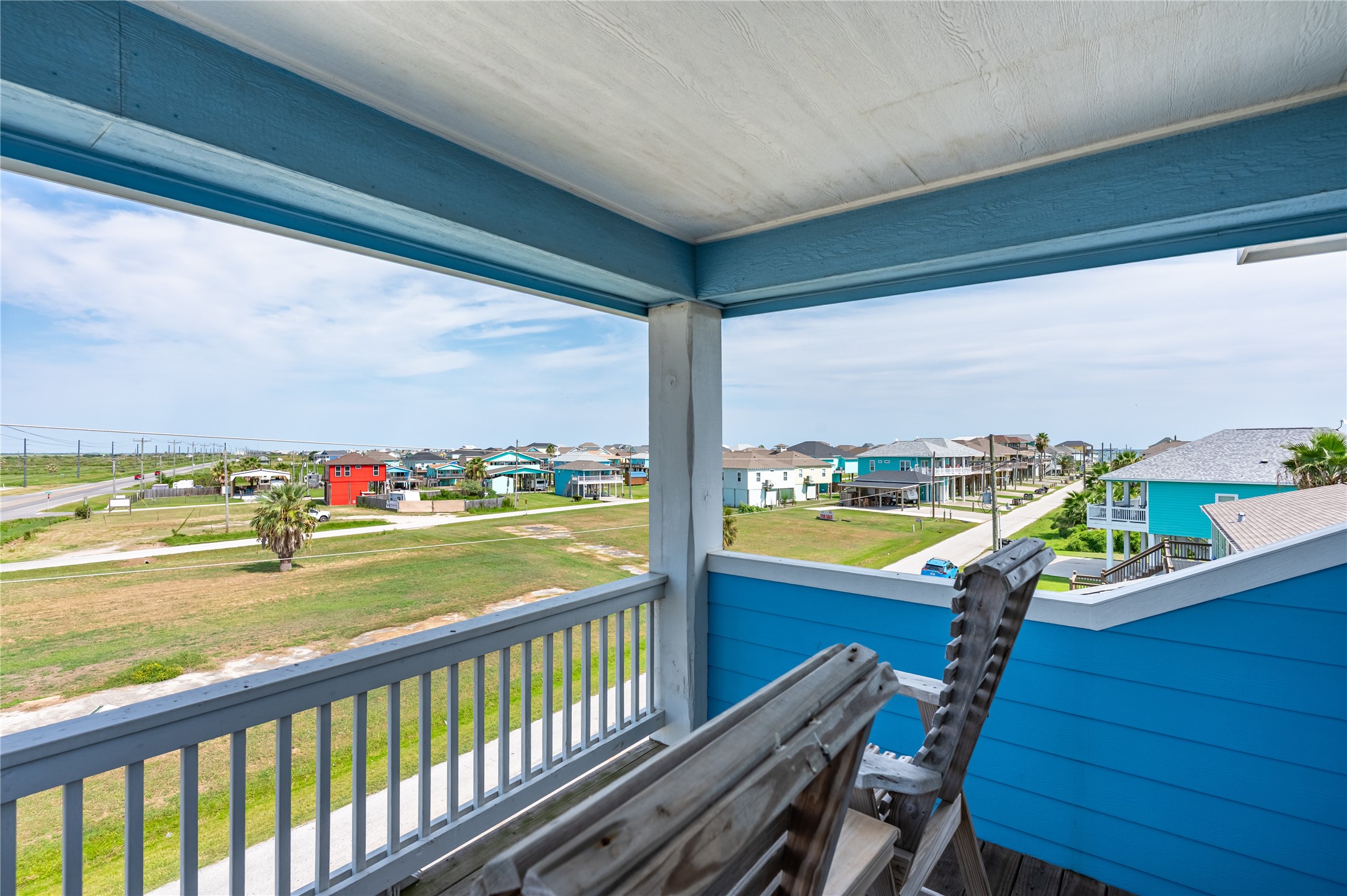 Step outside onto the covered balcony and settle in with an elevated view across the coastal neighborhood.