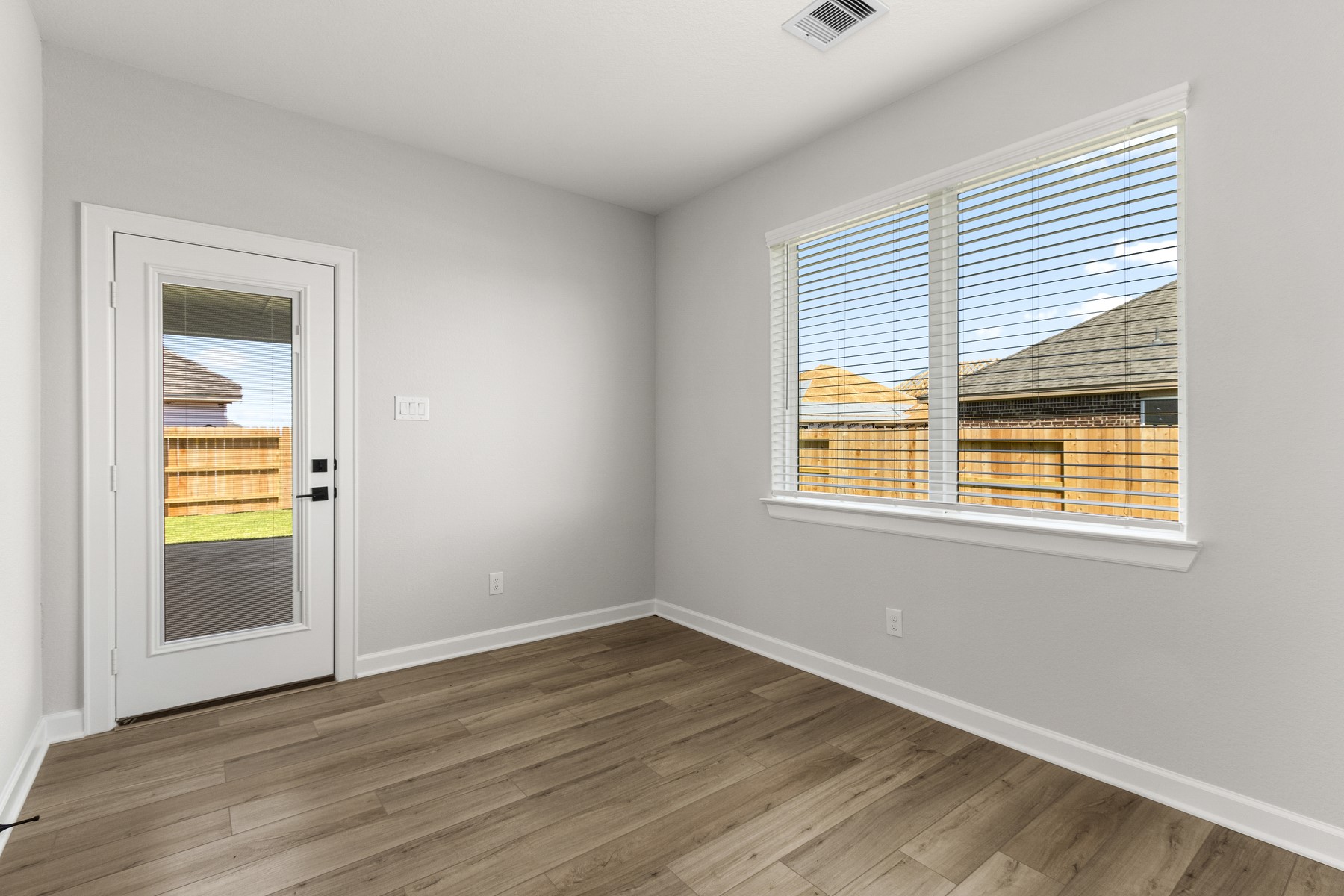 The dining room, located just off the kitchen, overlooks the back patio and backyard.